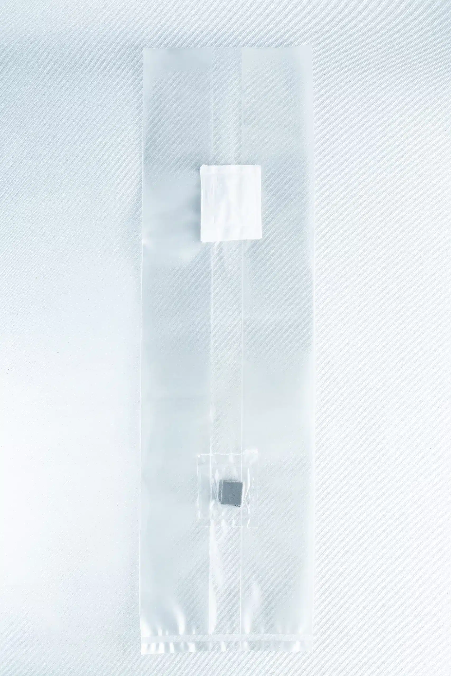 Unicorn Mushroom Grow Bags for spawn and substrate 6 A clear plastic Mushroom Grow Bag Unicorn for spawn and substrate, featuring two small compartments with items inside, is displayed on a white background.