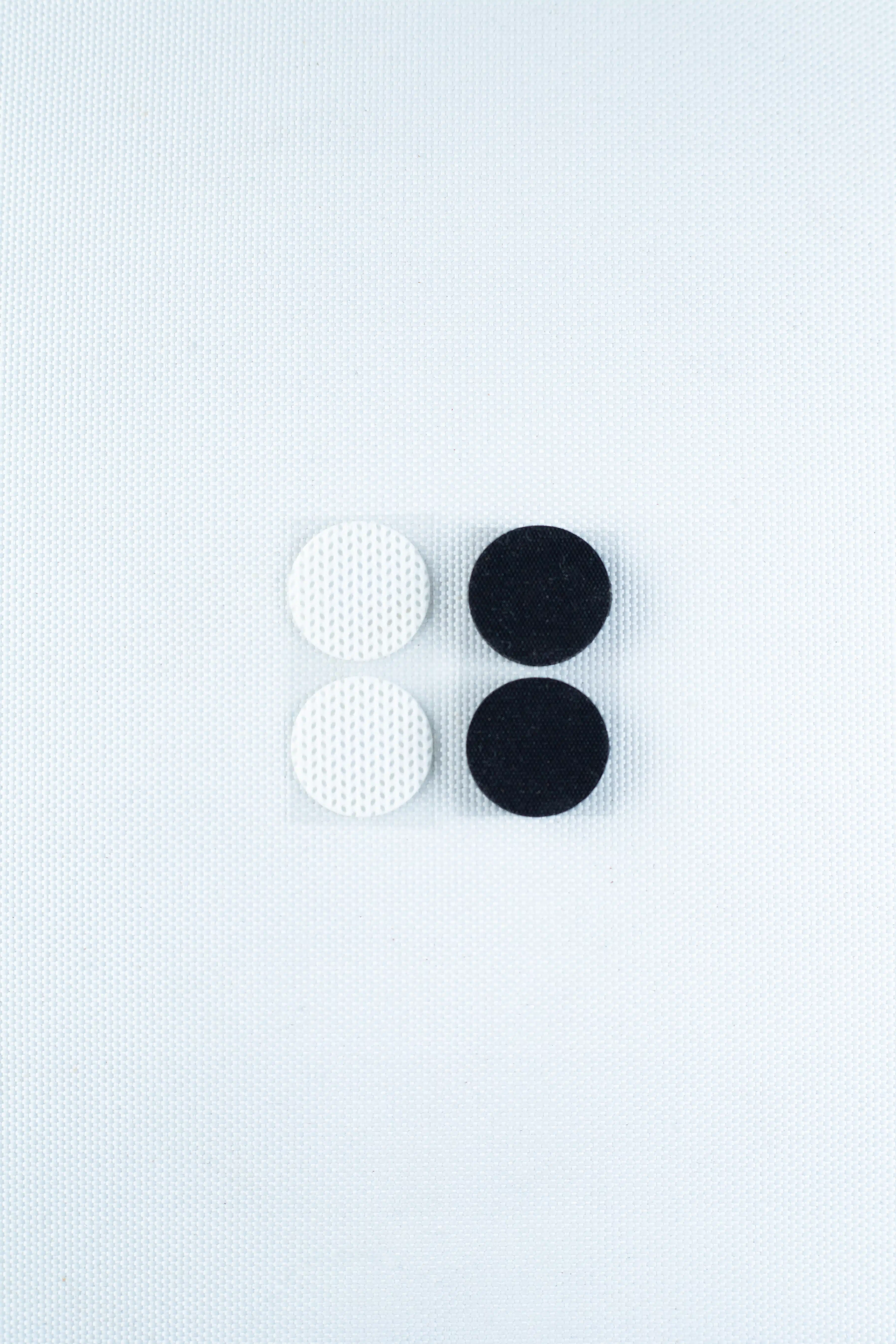 The Self-healing injection port & Air Vent Filter-3M, featuring two white and two black textured components, is arranged in a square on a light textured background.