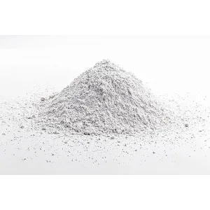 A small mound of Calcium Carbonate for Mycology, a fine white powder, is scattered on a white surface with a plain background.