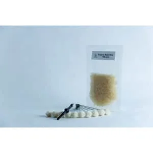 A packet of organic beeswax and a tool with white beads, ideal for your Mushroom Log Kit | Mushroom Inoculation Kit (Log Dowel), displayed on a clean white background.