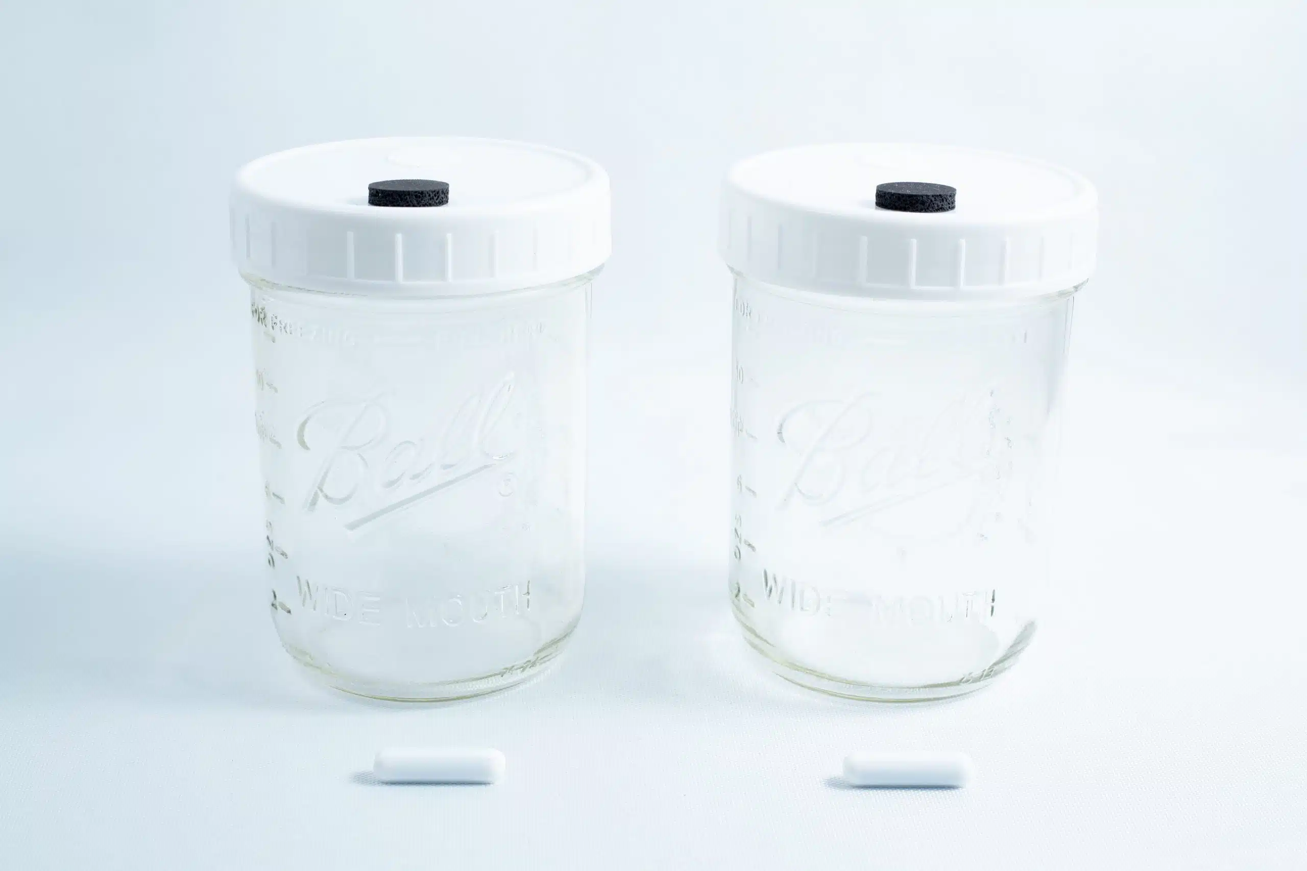 Two Mycology Ball mason jars, 1L each, genuine and autoclavable, with white lids featuring injection ports and air vents, displayed on a white background.