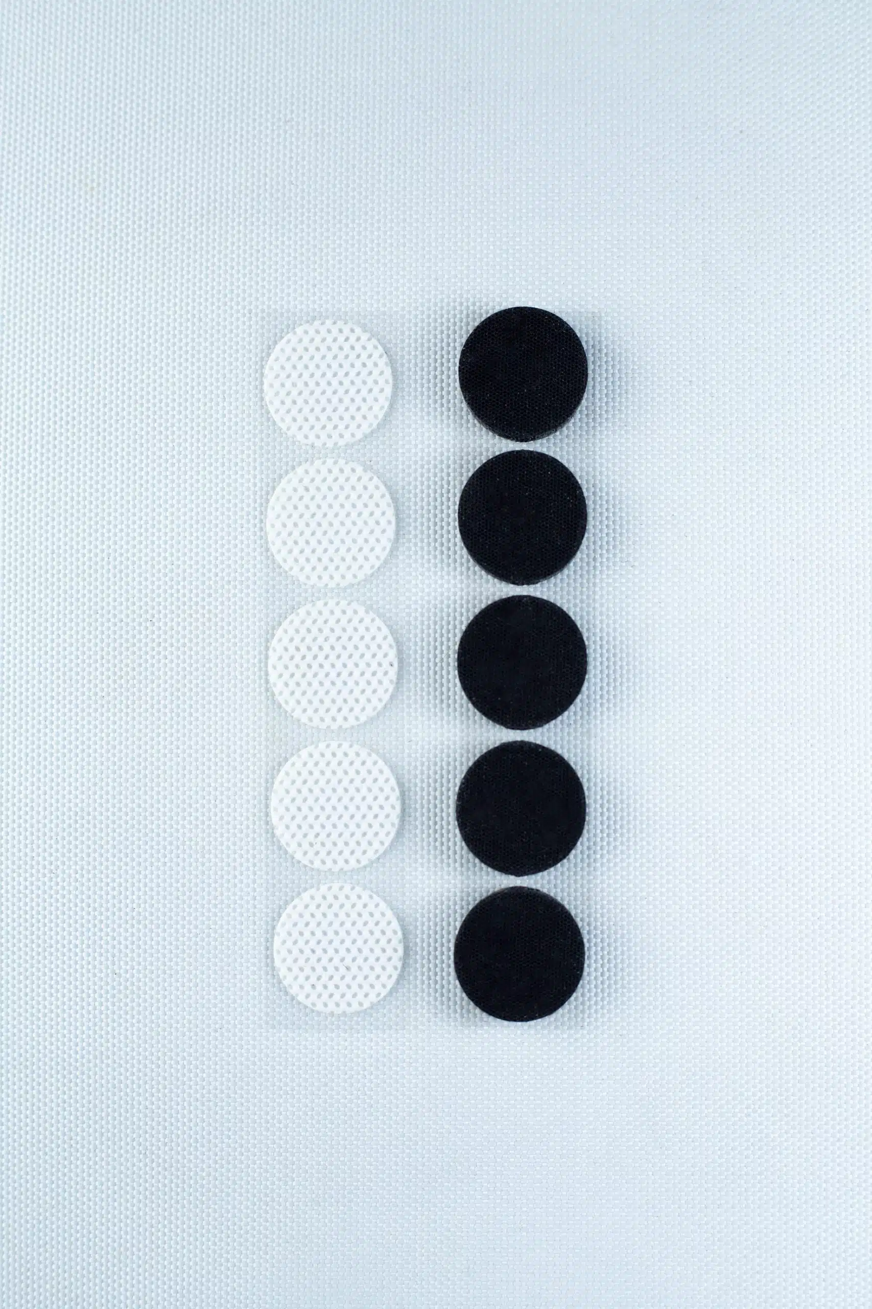 Six white and six black circles, resembling the Self-healing injection port & Air Vent Filter-3M, are arranged in two vertical lines on a white textured background.