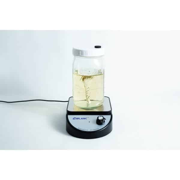 Ball mason jar with stirrer inside and magnetic stirrer machine