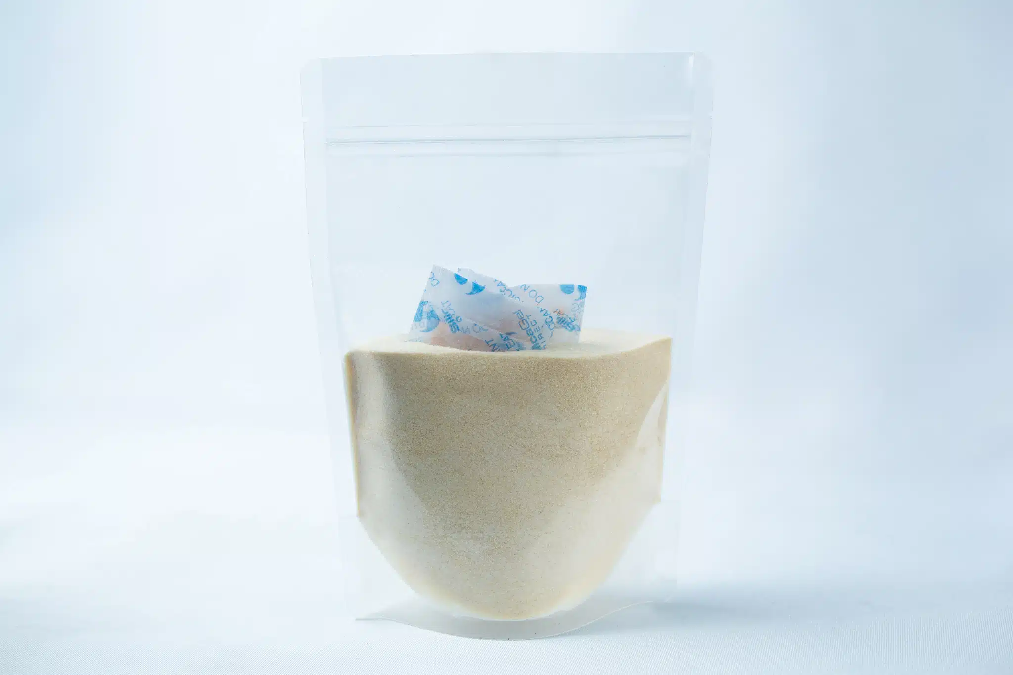 Liquid Culture Pre-mix | DLME | Now Extra Clear 2 Liquid Culture Pre-mix | DLME | Now Extra Clear: Clear plastic pouch containing Dextrose and Light Malt Extract powder blend, with a small silica gel sachet inside, displayed on a white background.