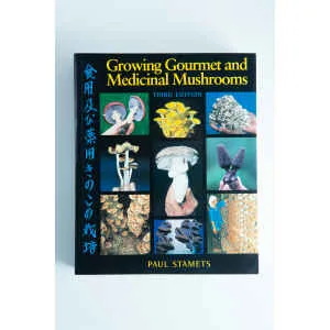 Book cover of "Growing Gourmet and Medicinal Mushrooms: Book By Paul Stamets" displays mushroom images with Japanese text—a great choice for anyone seeking informative books about mushrooms.