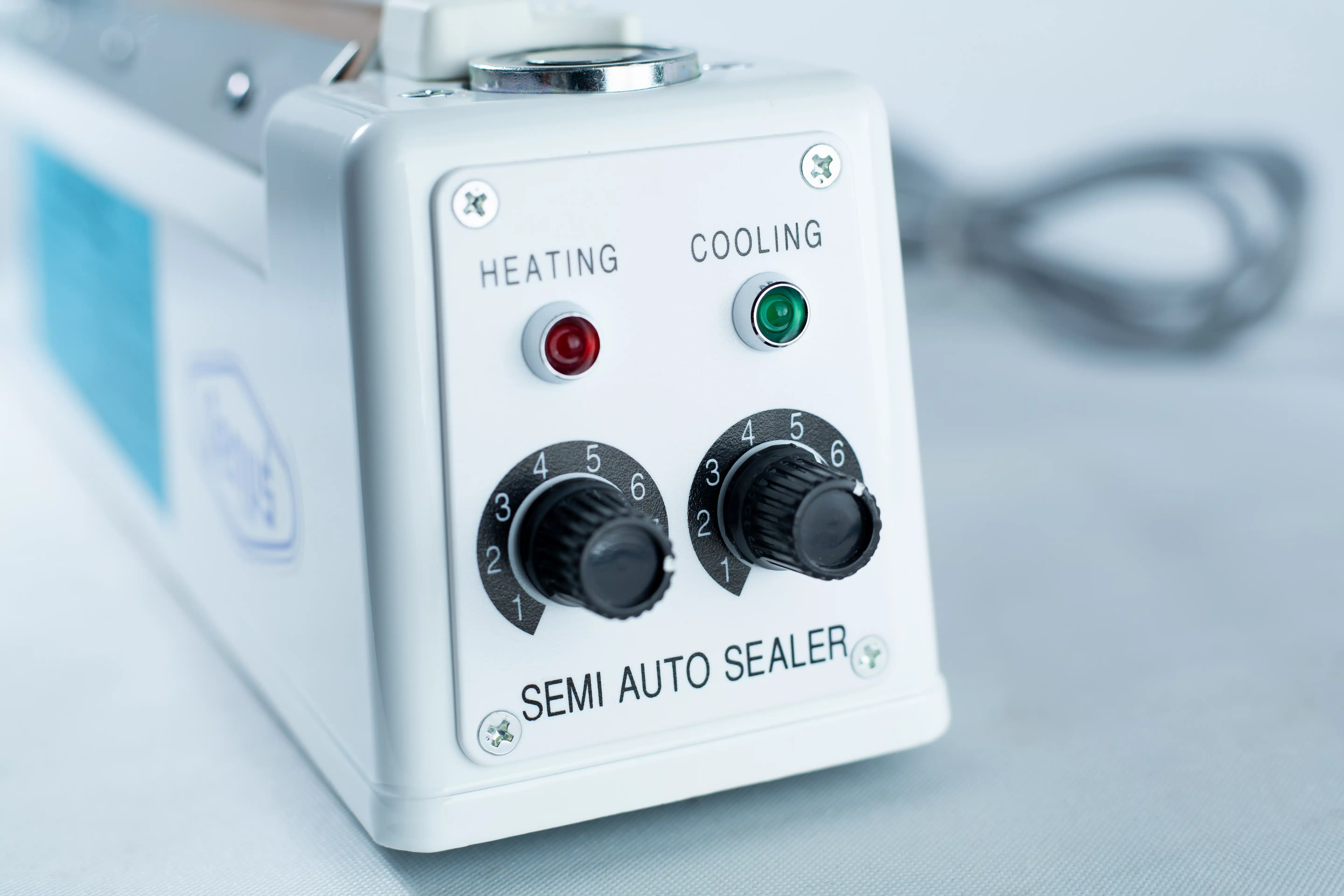 Heat Sealer 30cm Seal Width 5mm with cutter and Magnet 3 Close-up of the Heat Sealer 30cm Seal Width 5mm with cutter and magnet, featuring heating and cooling controls plus indicator lights.