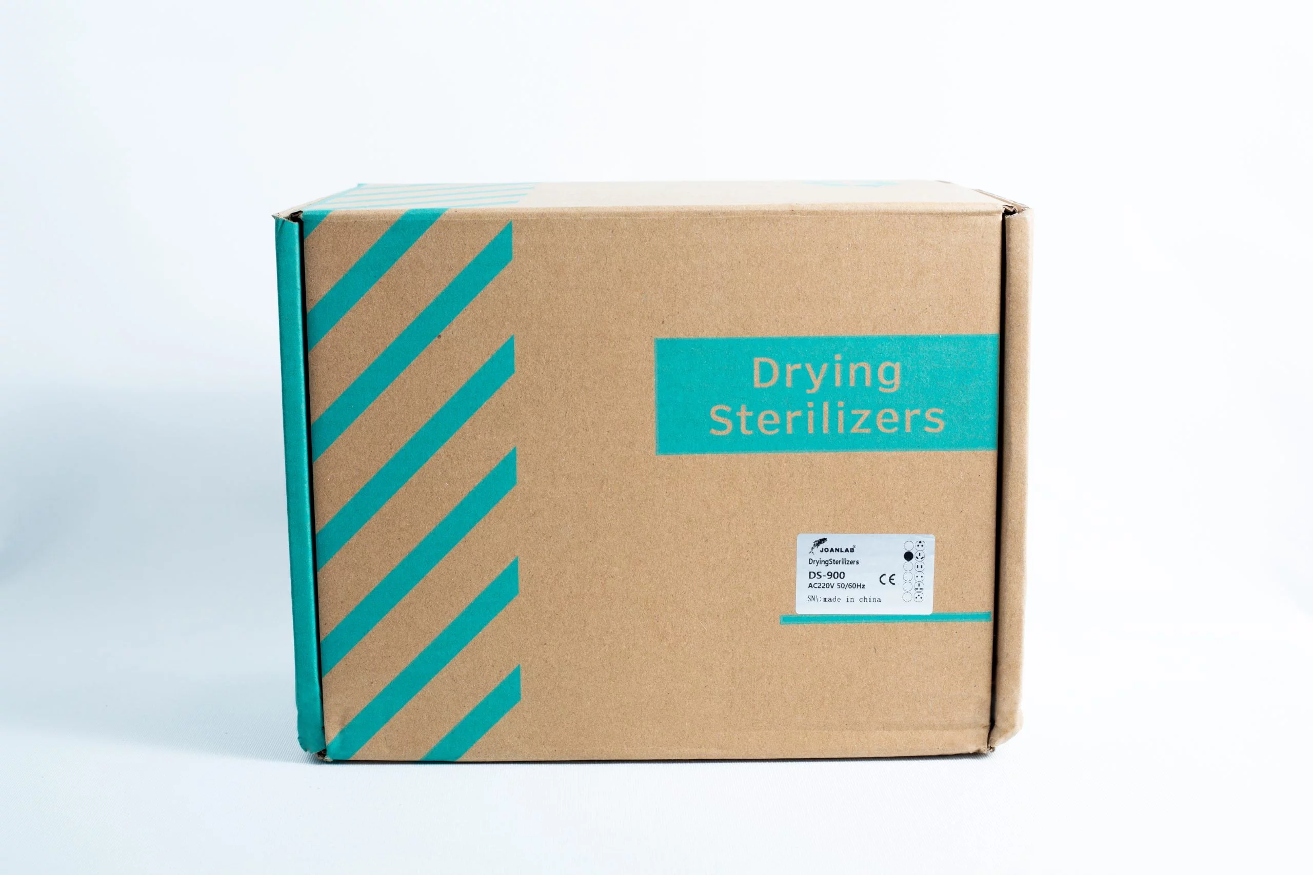 A cardboard box with teal diagonal stripes on white, labelled Infrared Steriliser Bacti Cinerator Lab tool, designed for storing lab steriliser units.