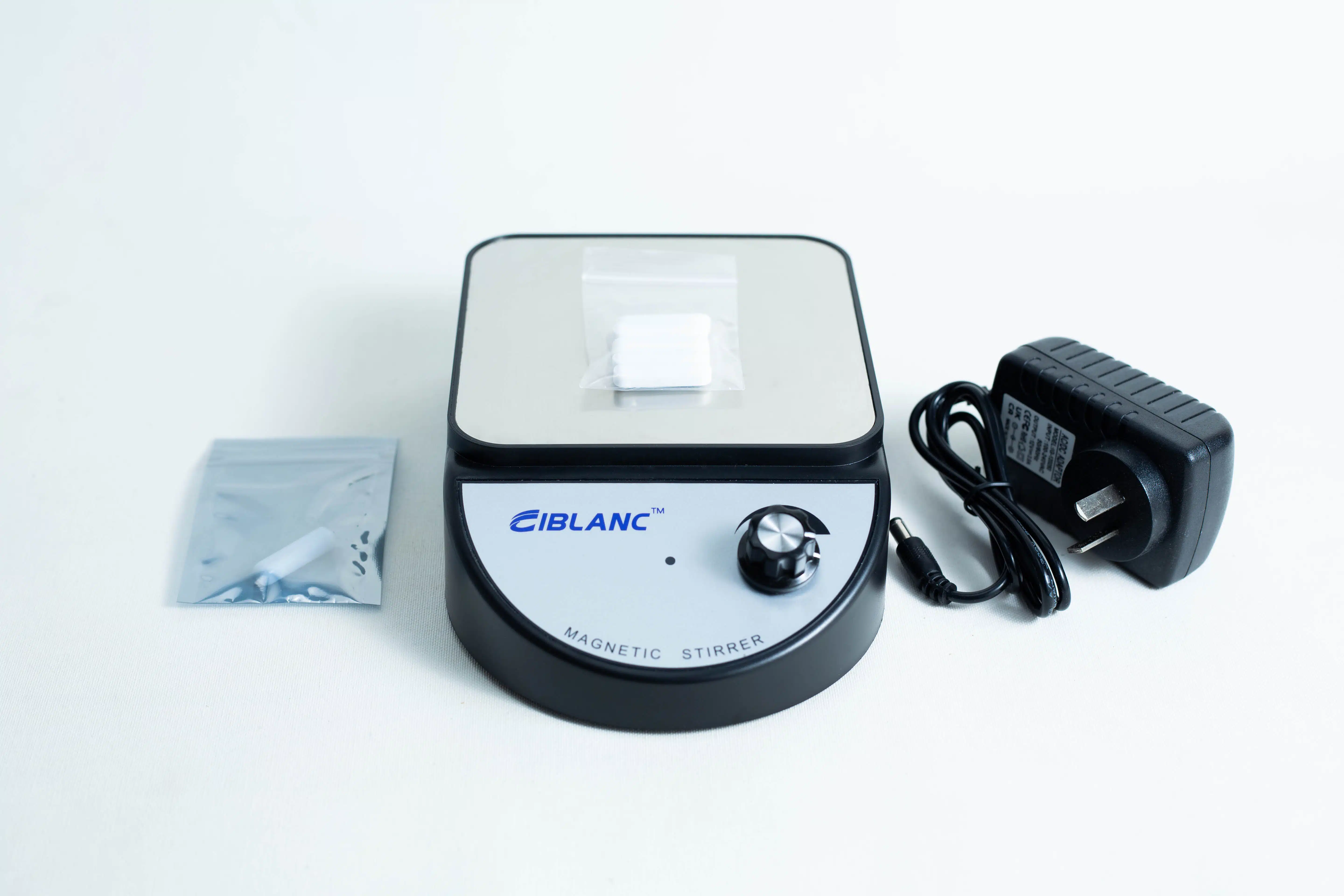 The Magnetic Stirrer Ciblanc 3500rpm is shown on a white background with a power adaptor and a small bag containing a magnetic stir bar.