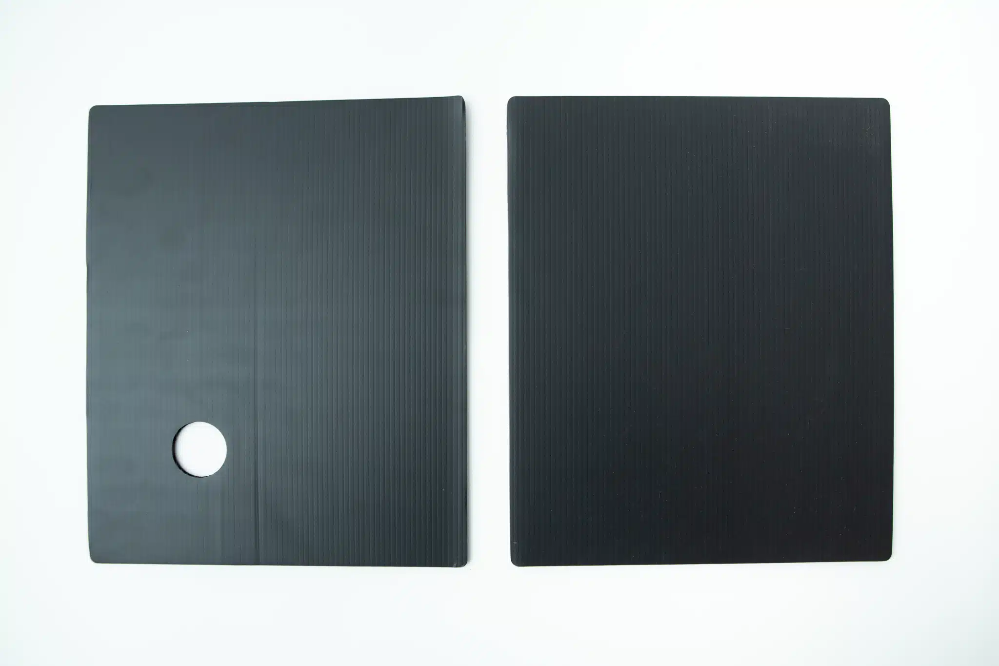 Two black rectangular mats, one with a circular hole, placed side by side on a white background—perfect for use with the Inflatable Monotub Kit for Growing Mushrooms - Boomer Shroomer V 2.0.