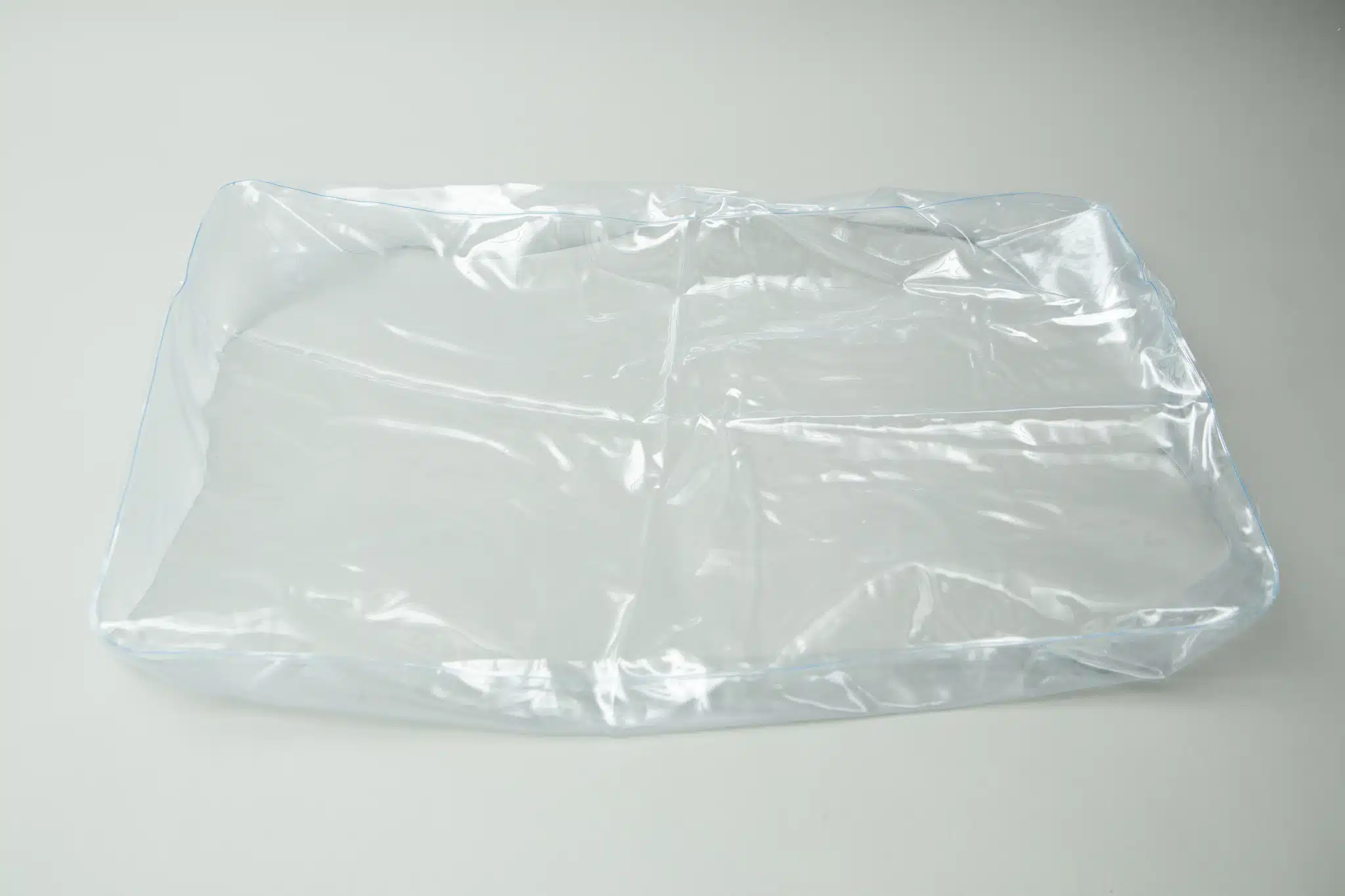 The Inflatable monotub kit for Growing mushrooms—Boomer Shroomer V 2.0—sits empty and transparent on a white surface, perfect for mushroom cultivation set-ups.