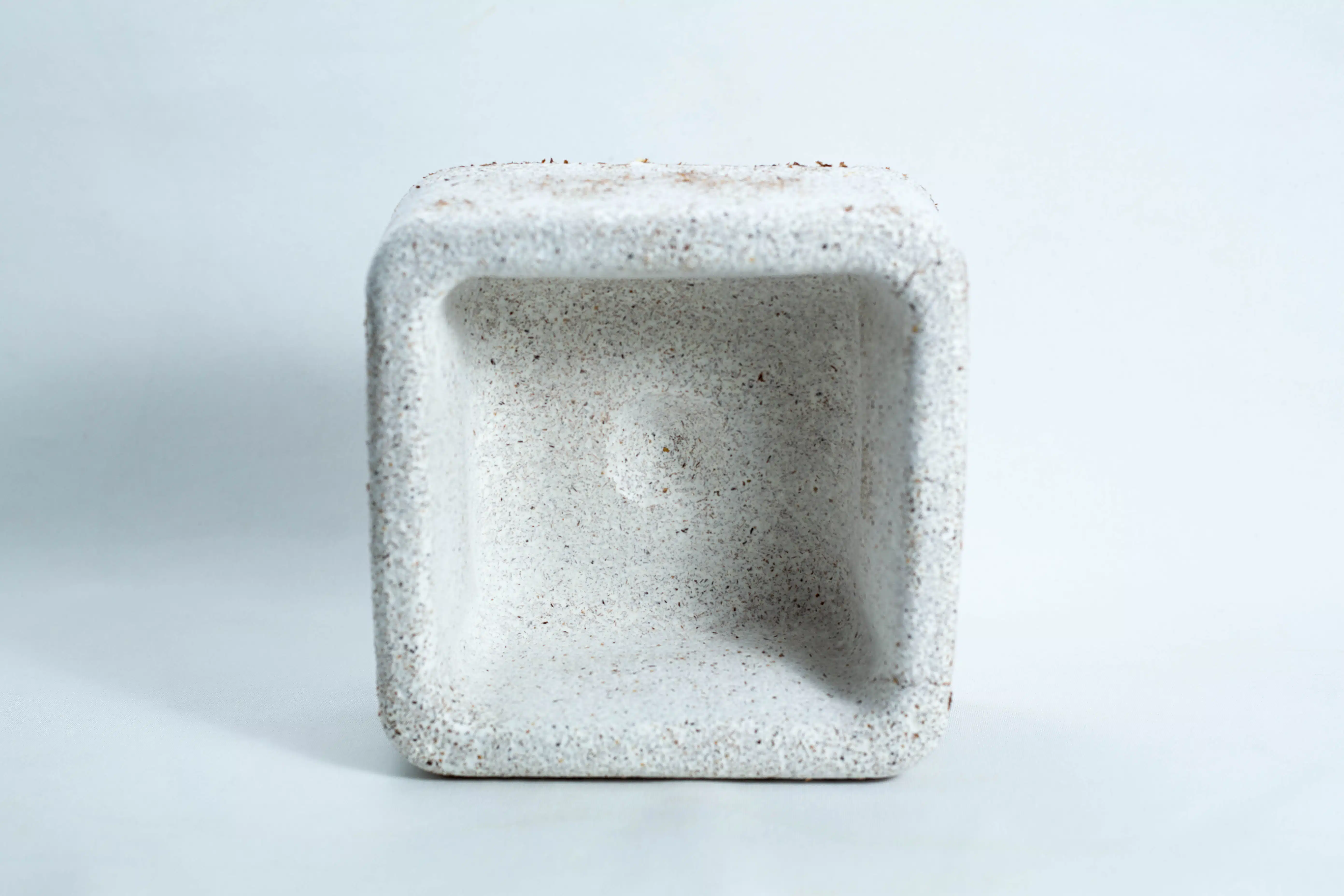 A square, white, textured Mycelium Mould Growth Form – Plant Pot Heavy Duty (Reusable) is shown from above on a plain light background, highlighting its unique design.