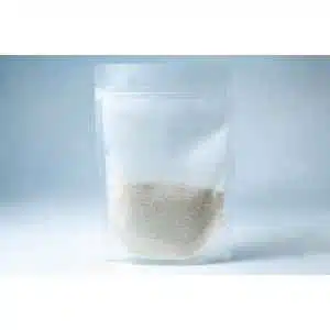 A clear resealable plastic pouch containing Natural Gypsum coarse gradeโwhite granules used as a mushroom supplement for grain and substrateโstands upright on a light background.
