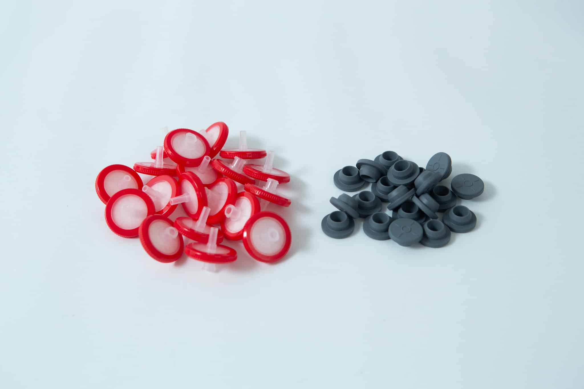 Rubber Self Healing Injection port and Syringe Filter PTFE for Mycology 2 A set of Rubber Self-Healing Injection ports and red-and-white PTFE Syringe Filters for Mycology are arranged together on a white surface.