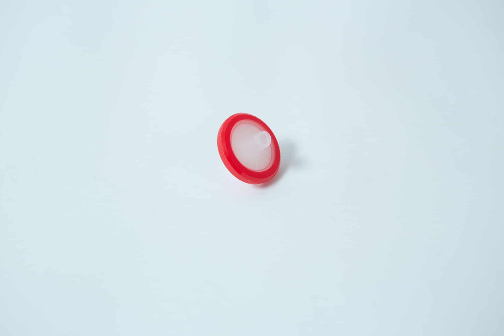Rubber Self Healing Injection port and Syringe Filter PTFE for Mycology 3 The Rubber Self-Healing Injection Port and Syringe Filter PTFE for Mycology, featuring a round red plastic body with a white centre and injection port, is displayed on a plain white background.