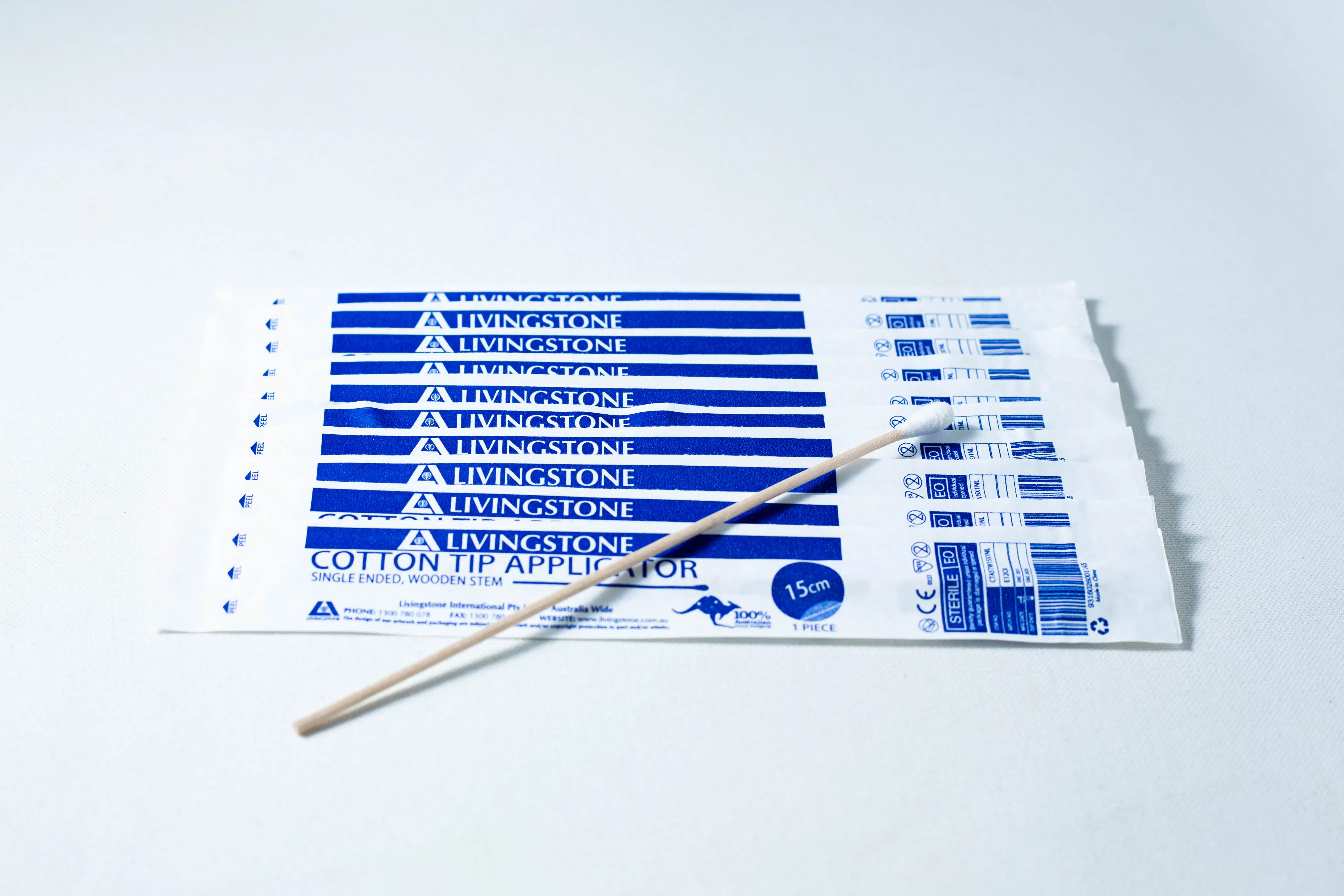 Eight packs of Sterile Cotton Tip Applicator/Swab in blue and white, each containing one sterile cotton tip swab, with a single wooden applicator on top.