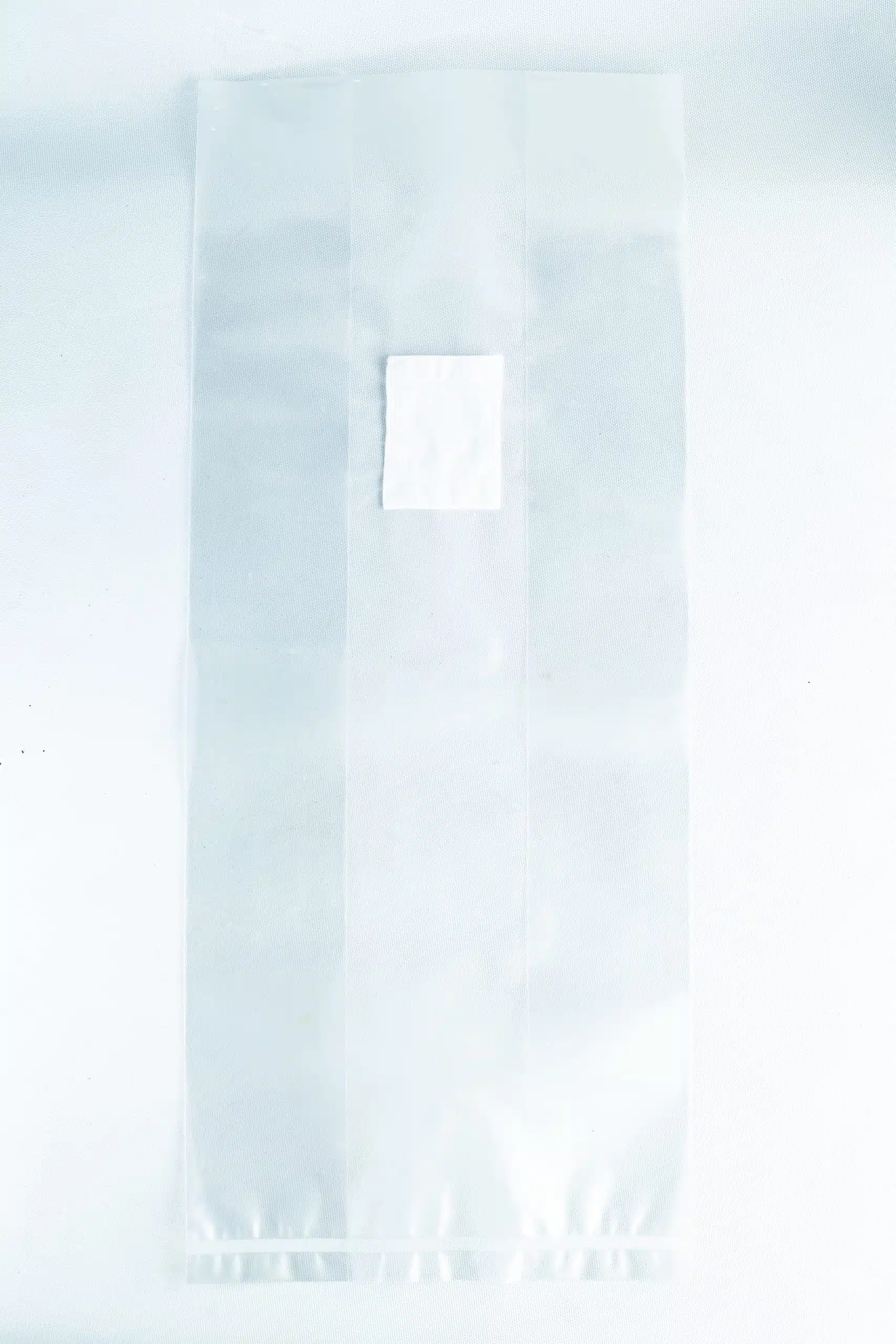 Unicorn Mushroom Grow Bags for spawn and substrate 3 A small white square sits on a large transparent sheet made of material used in Mushroom Grow Bags Unicorn for spawn and substrate, all placed on a white background.