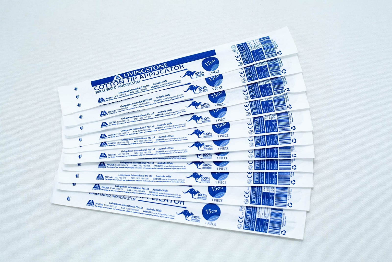 Sterile Cotton Tip Applicator/ Swab 24 Ten sterile cotton bud sticks, each individually wrapped and labelled with blue text, are arranged on a white surface.