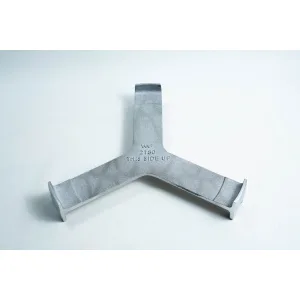 Grey metal object with three prongs and “THIS SIDE UP” engraved at the centre, placed on a white surface.