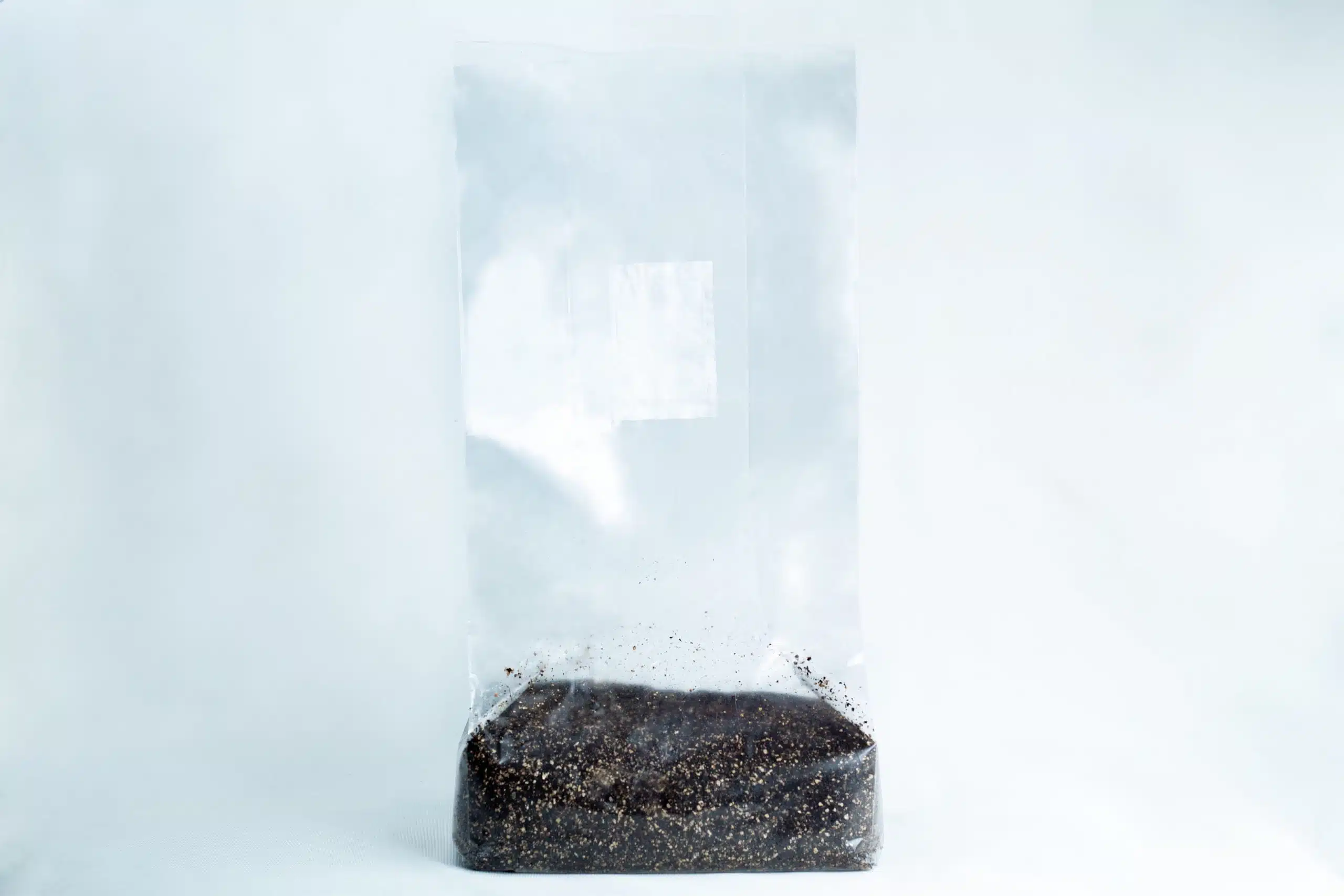 The CVG Substrate | CVG Monotub Mushroom Bulk Substrate 2KG Coco Verm Gypsum is shown as a clear plastic bag of dark substrate, perfect for mushroom cultivation, set against a plain white background.