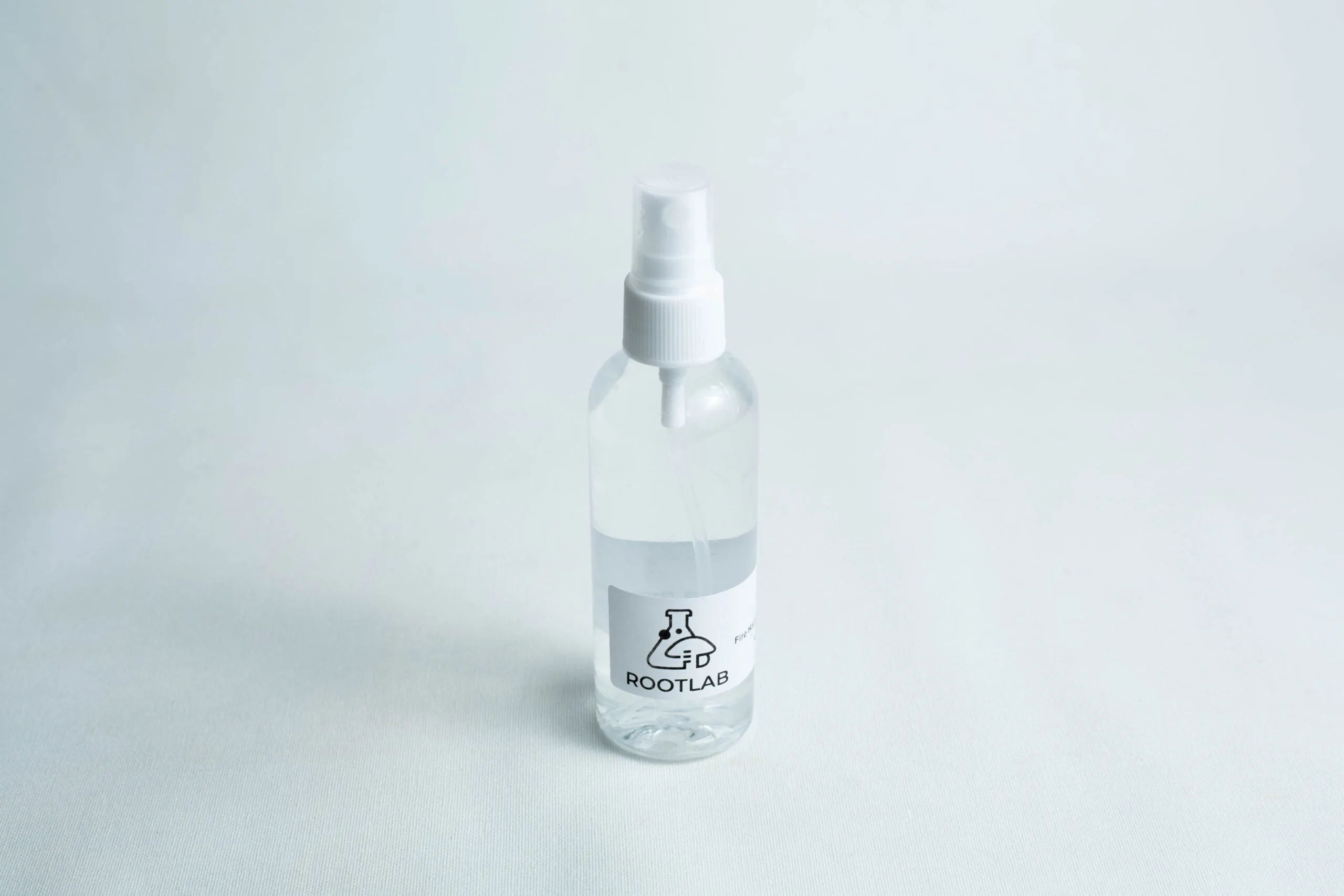 Monotub Mushroom Growing Kit-Premium 4 A clear 100ml spray bottle labelled ROOTLAB with a laboratory flask logo, containing 70% isopropyl alcohol, is placed on a white background.