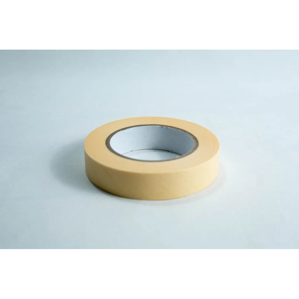 A roll of beige masking tape on a white surface.