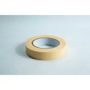 A roll of beige masking tape on a white surface.