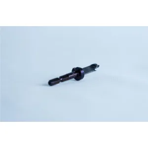 A small metallic tool with a cylindrical handle lies on a white surface, orientated diagonally.