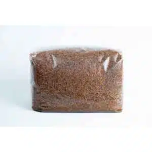 A clear plastic bag contains finely ground brown Masters Mix Mushroom Substrate, made from sawdust and soya pellets.