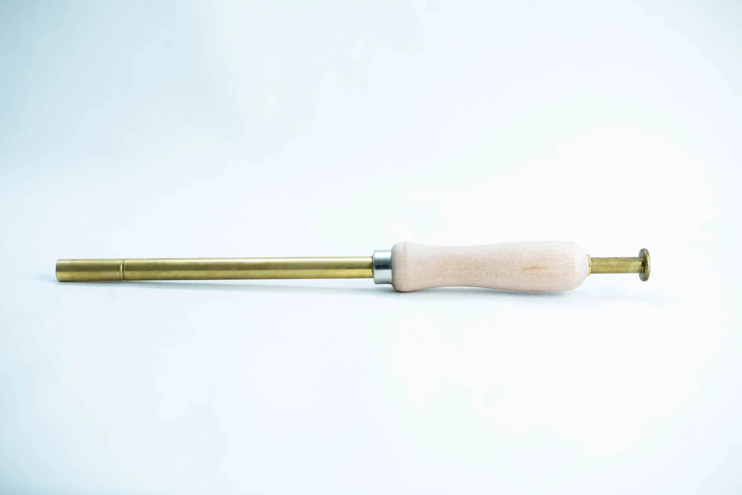 Sawdust Log Inoculation Tool for 12.5mm hole 1 A brass and wood tool with a cylindrical handle and narrow metal shaft on a white background.
