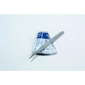 A metal scalpel rests on top of a blue and white sterile packaging on a white surface.