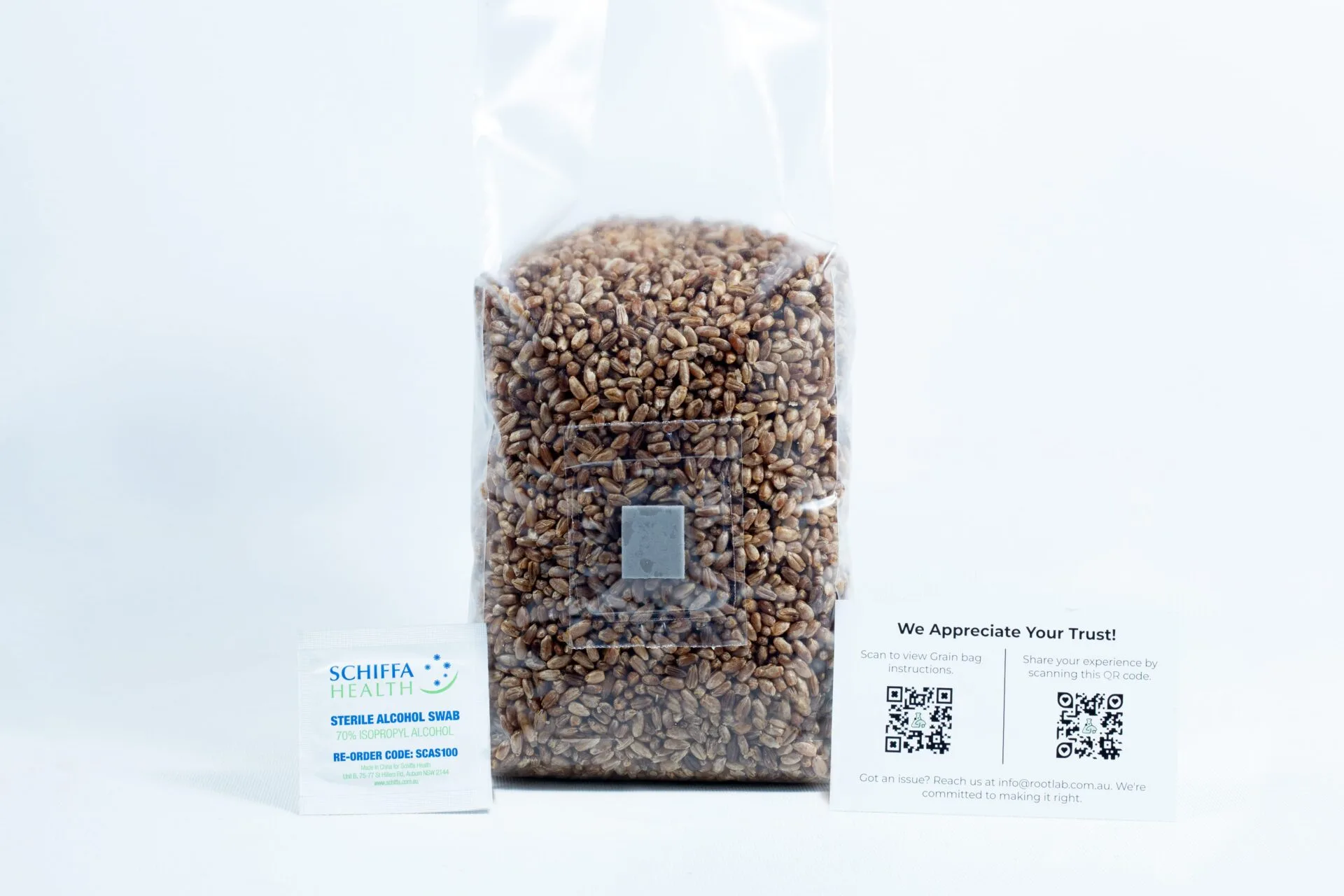 Monotub Mushroom Growing Kit-Premium 7 A sealed bag of grains for the Monotub Mushroom Growing KitโPremium, accompanied by a packet and a card displaying QR codes, is placed beside it on a white background.