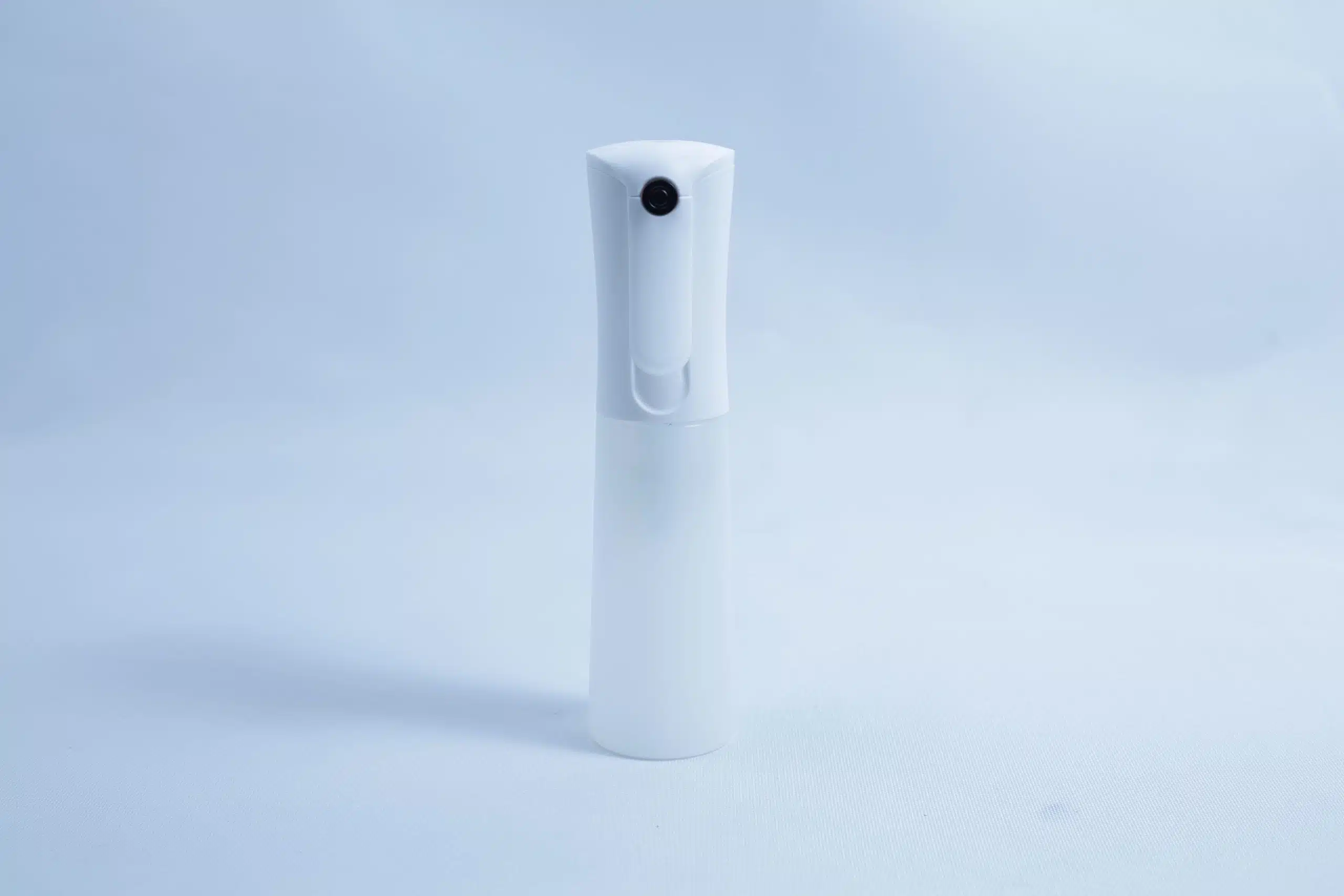 Monotub Mushroom Growing Kit-Premium 3 A white plastic spray bottle, ideal for use with the Monotub Mushroom Growing Kit-Premium, stands upright on a plain light blue background.