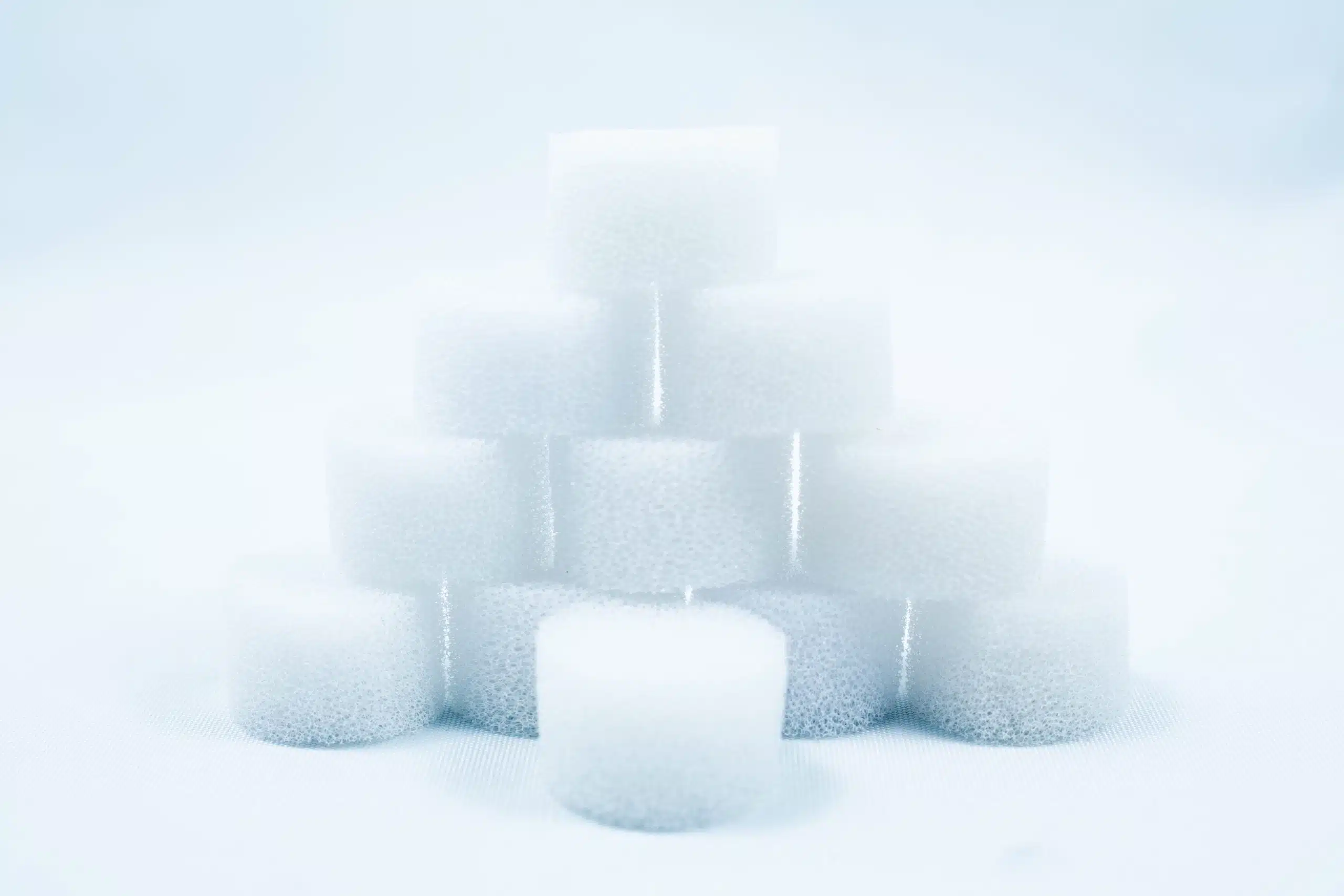 Monotub Mushroom Growing Kit-Premium 11 A pyramid of white, round foam sponges stacked on a white surface with a soft, light background.