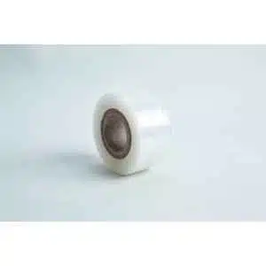 A small roll of Grafting Tape to seal agar plates or for plant grafting, with a brown cardboard core, rests on a light surface.