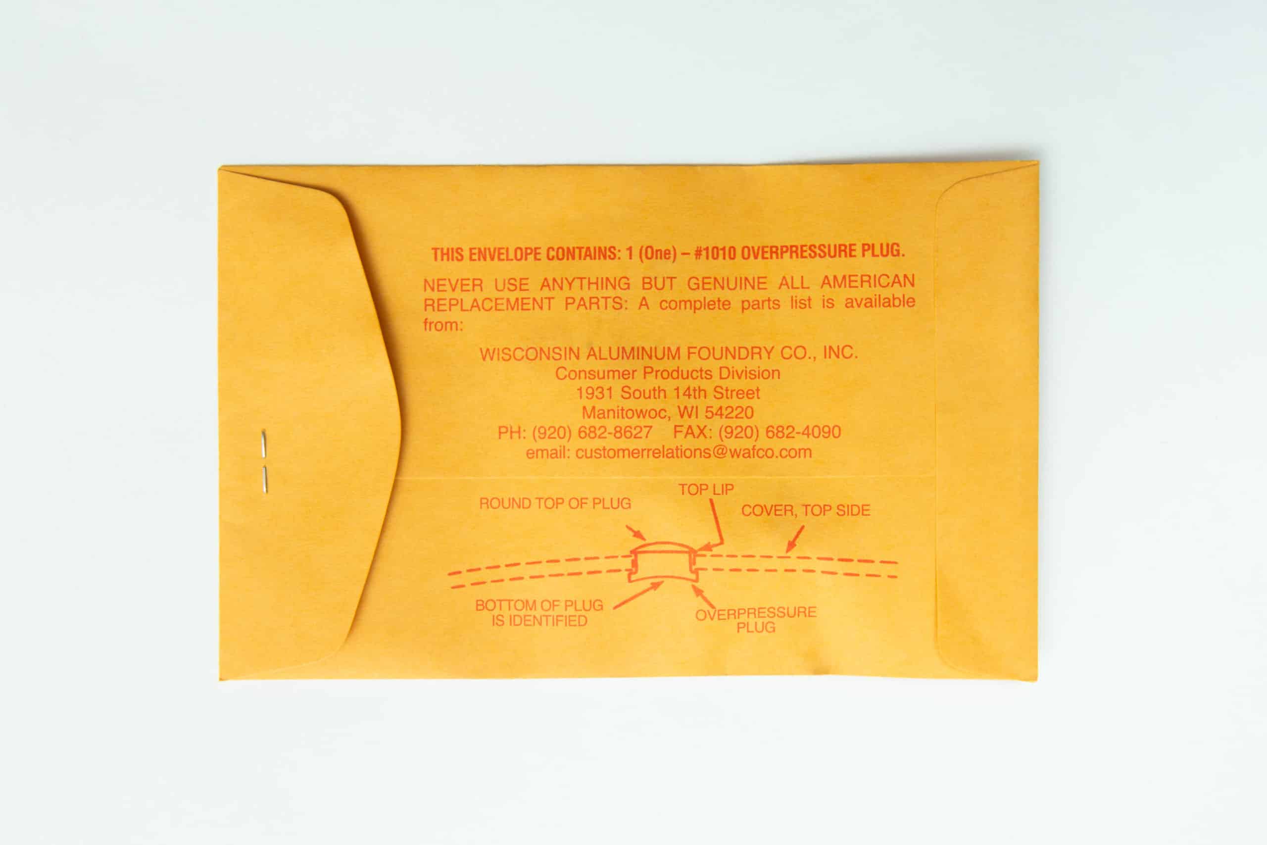 All American rubber overpressure plug for steriliser | Orange | Part 1010 2 The All-American rubber overpressure plug for steriliser (Orange, Part 1010) is shown on a white background in a brown envelope with red printed instructions, sealed by a metal clasp.