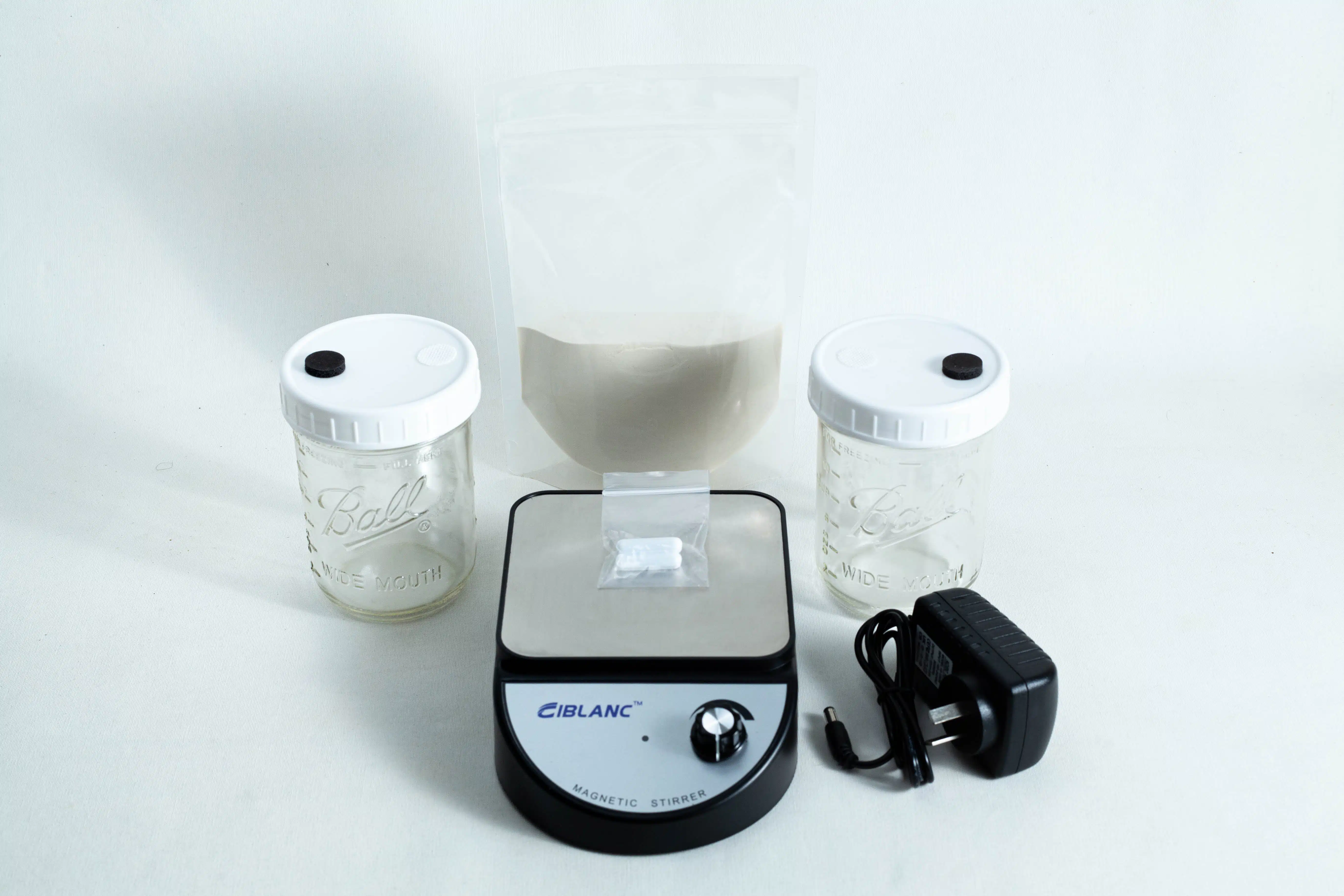 The Liquid Culture Kit with Jar, Magnetic Stirrer and LC Mix includes two jars, a clear pouch of LC mix powder, a magnetic stirrer, and a power adaptor—all shown on a white background.
