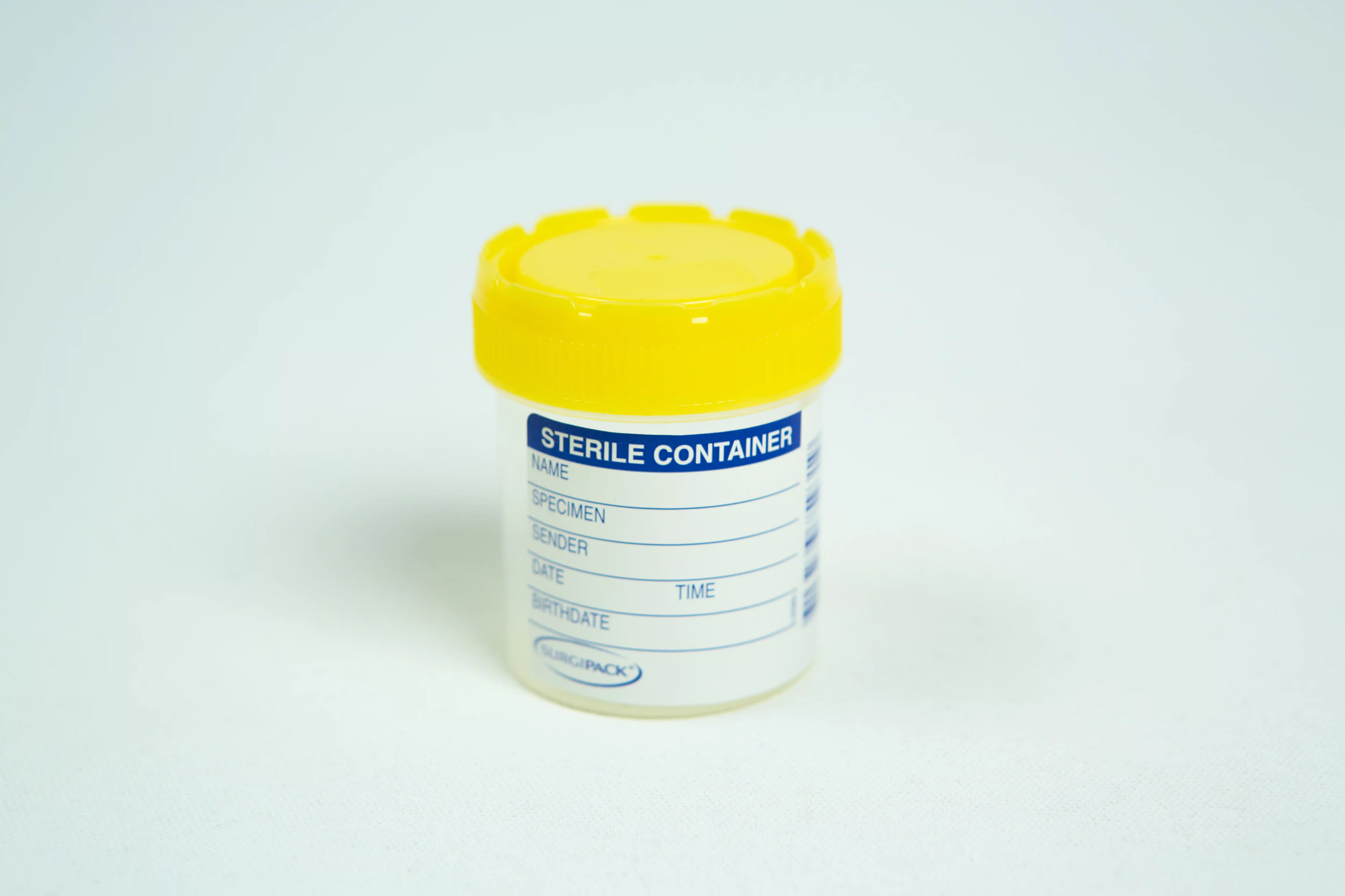 A sterile plastic specimen container with a yellow lid and labelling area—perfect for use with the Spore Print to Spore Syringe Transfer Kit.