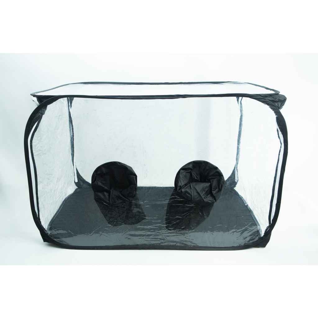 Clear pop-up box with two black fabric sleeves on the bottom panel, used for handling items inside safely.
