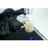 Pouring agar plate inside still air box on petri dish