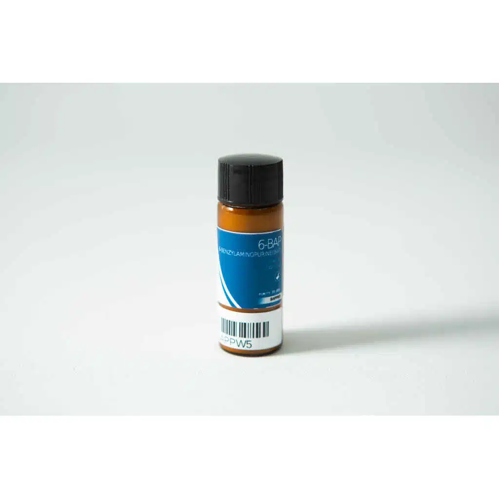 A small brown bottle labelled "Plant Cell Benzylaminopurine (6-BAP) Powder" with a blue label, black cap, and barcode sits on a white surface.