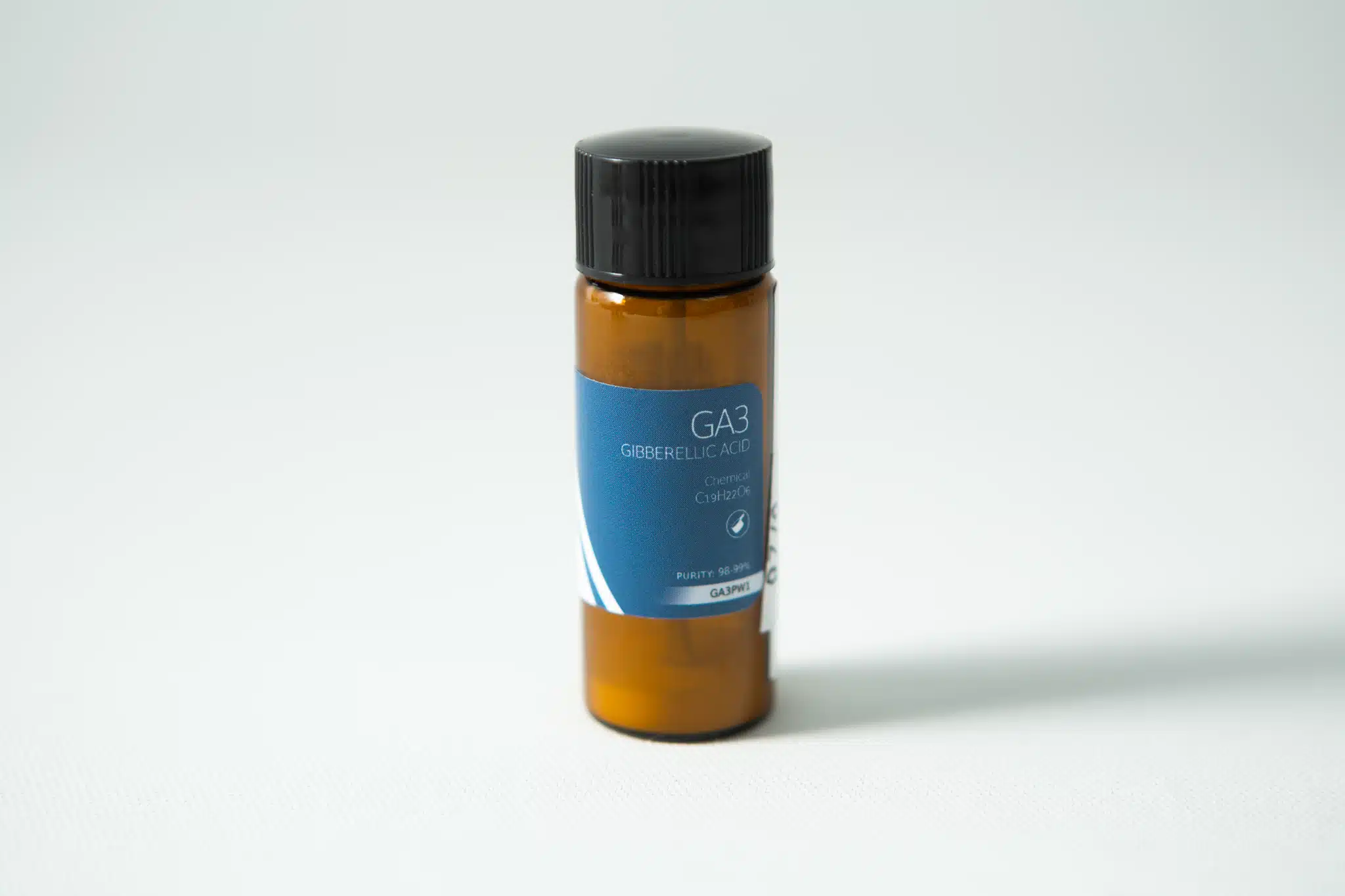 A small brown bottle with a blue label reading "Plant Cell Gibberellic Acid (GA3) Powder" sits on a white surface.