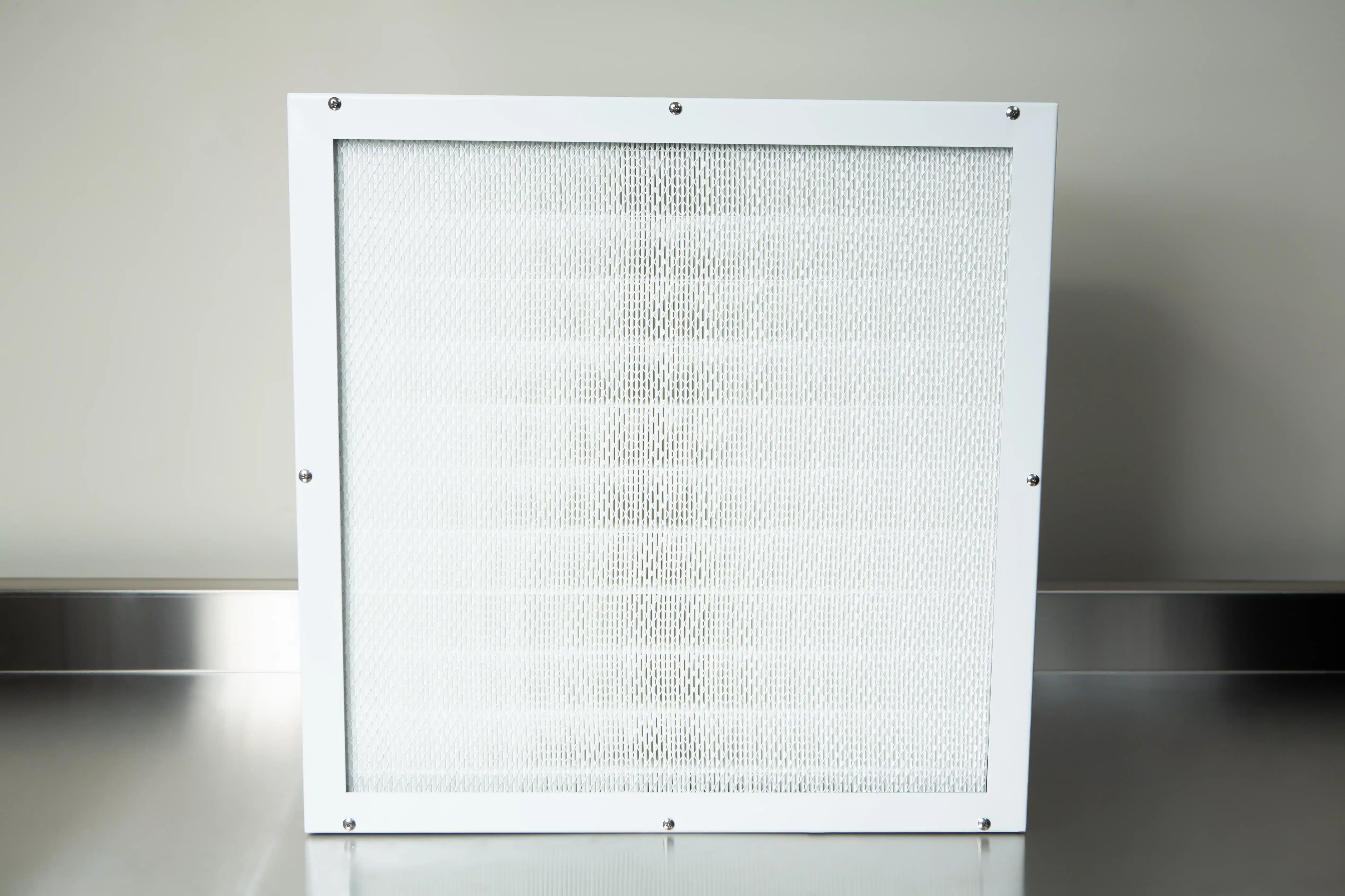Laminar Flow Hood HEPA Airfilter H14 w/prefilter 60x60x35cm 1 The Laminar Flow Hood HEPA Airfilter H14 with prefilter (60x60x35cm) and metal frame is shown on a reflective stainless steel surface.