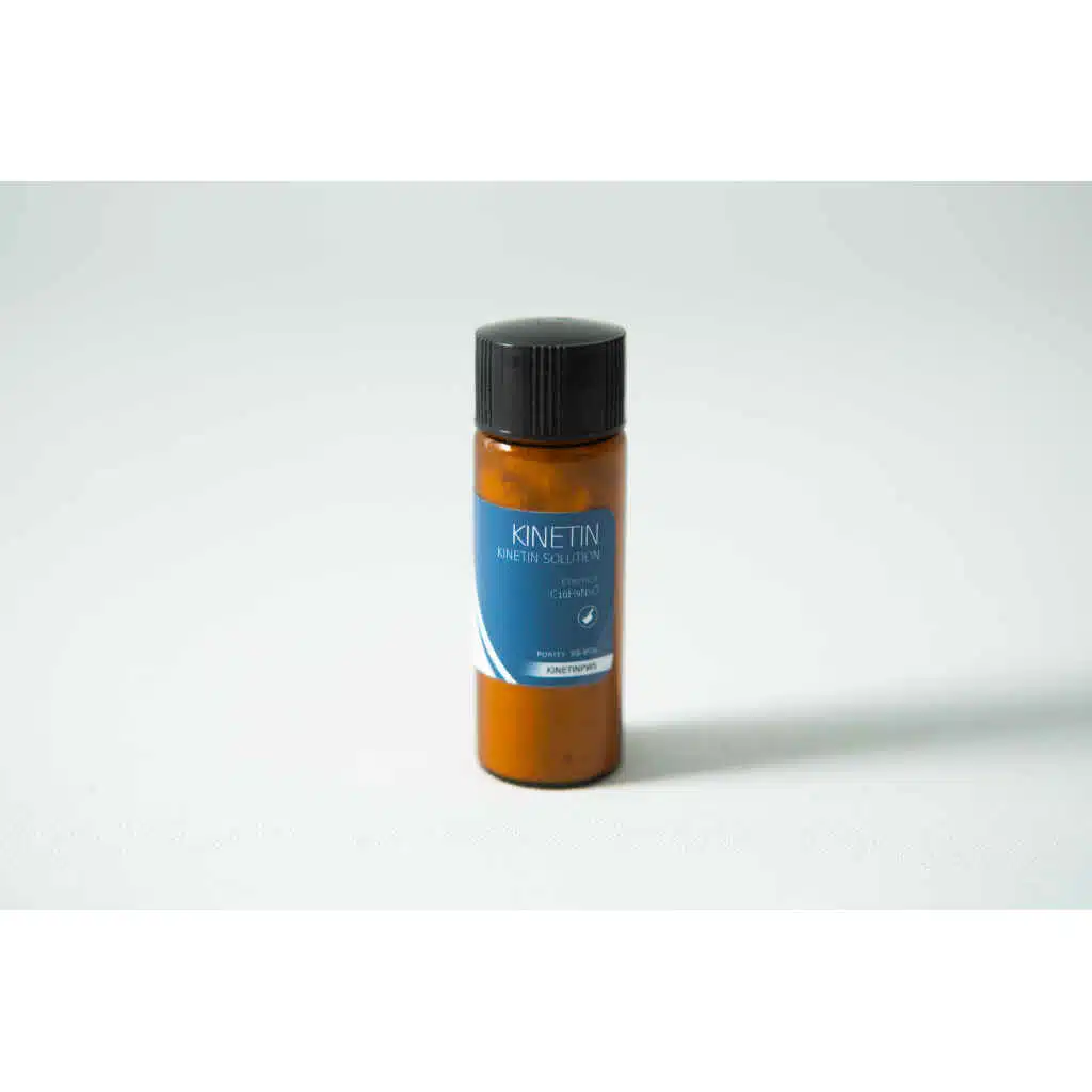 Brown bottle with black cap and blue label reading “Plant Cell Kinetin Powder” on a plain light background.