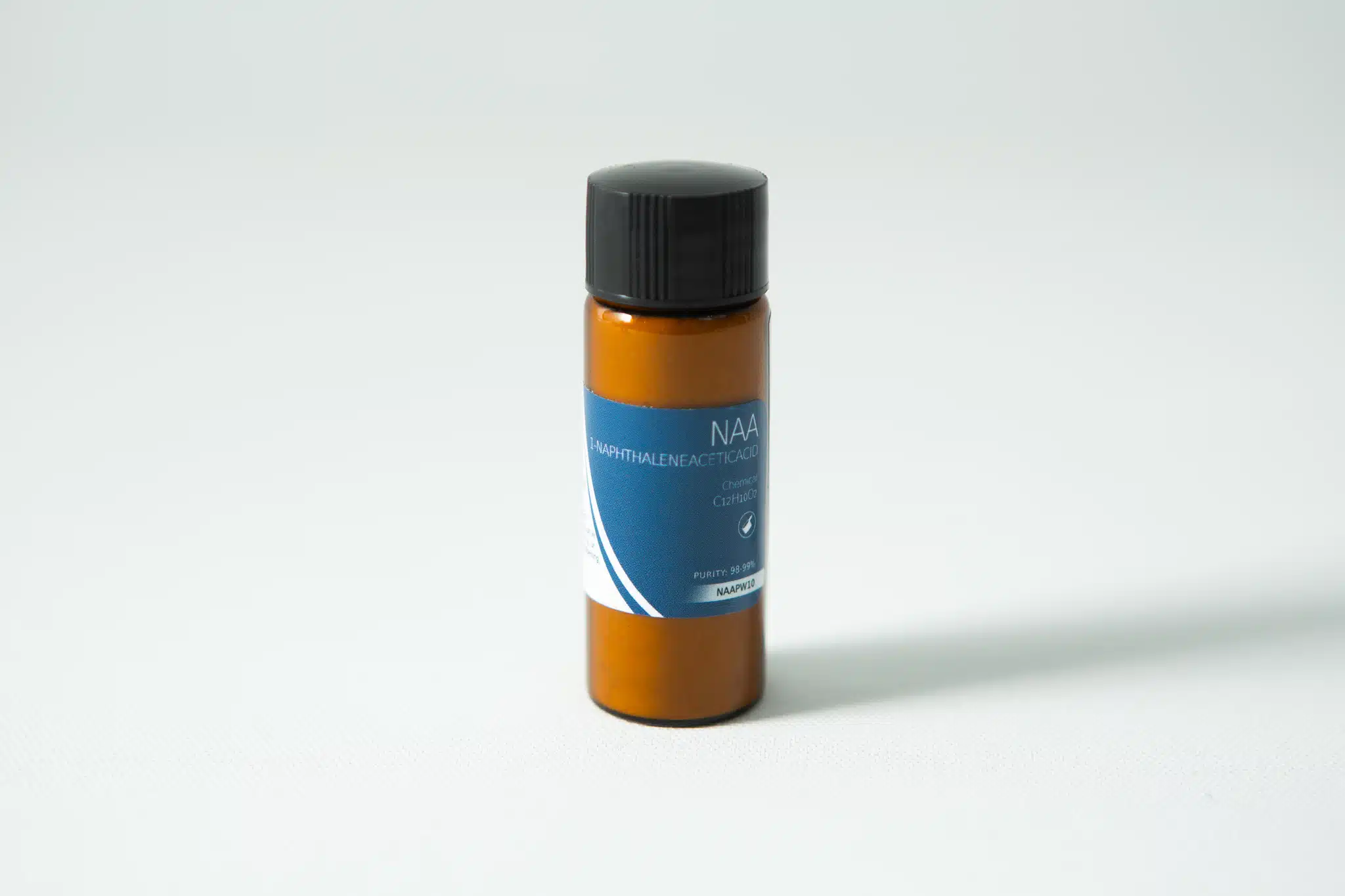 Plant Cell Naphthaleneacetic (NAA) Powder 1 Small brown plastic bottle with black cap and blue label reading "Plant Cell Naphthaleneacetic (NAA) Powder" on a white surface.