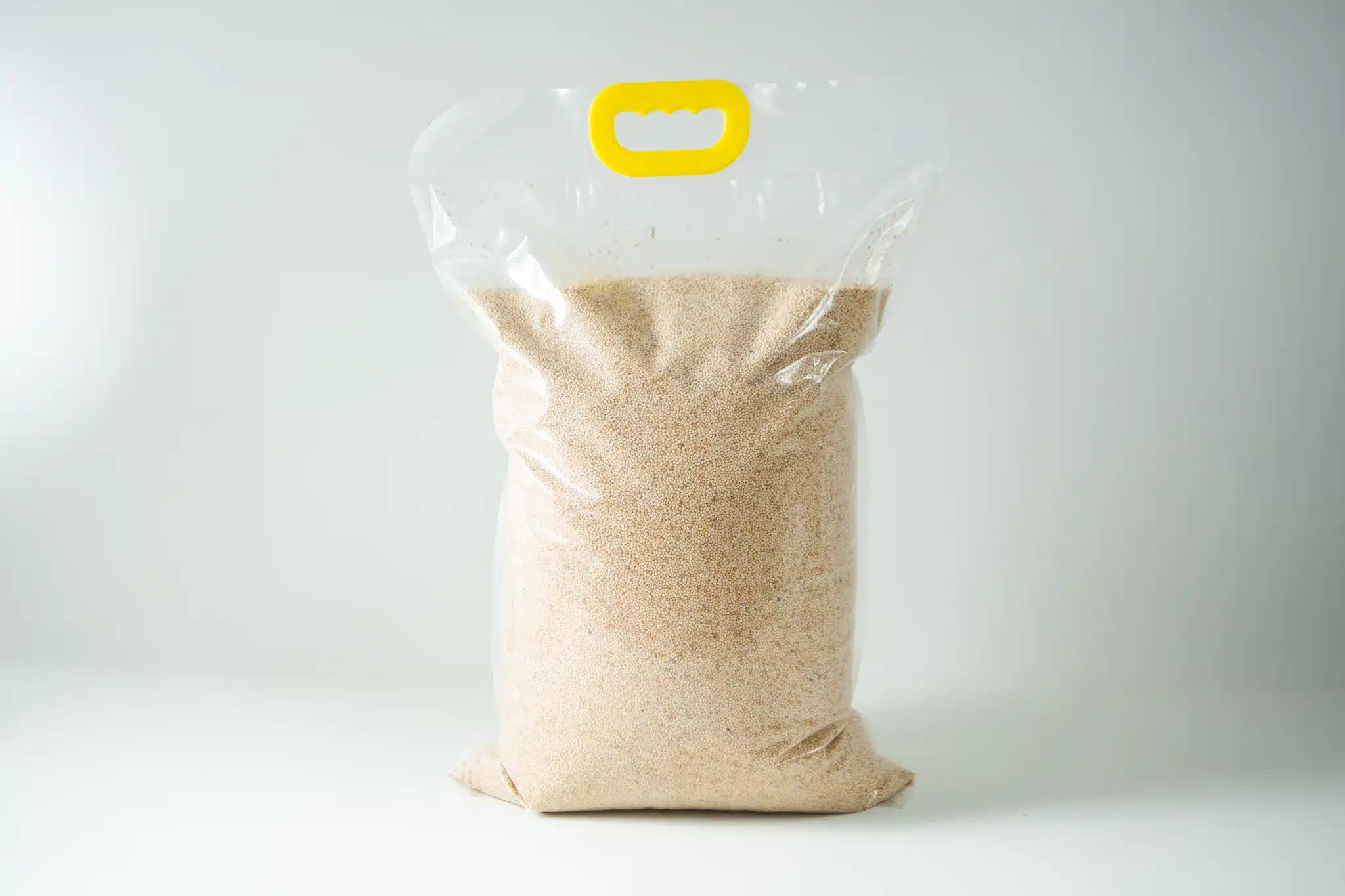 A clear plastic bag containing Certified Organic Biodynamic Rye berry grain, light brown granules, sealed with a yellow handle at the top.