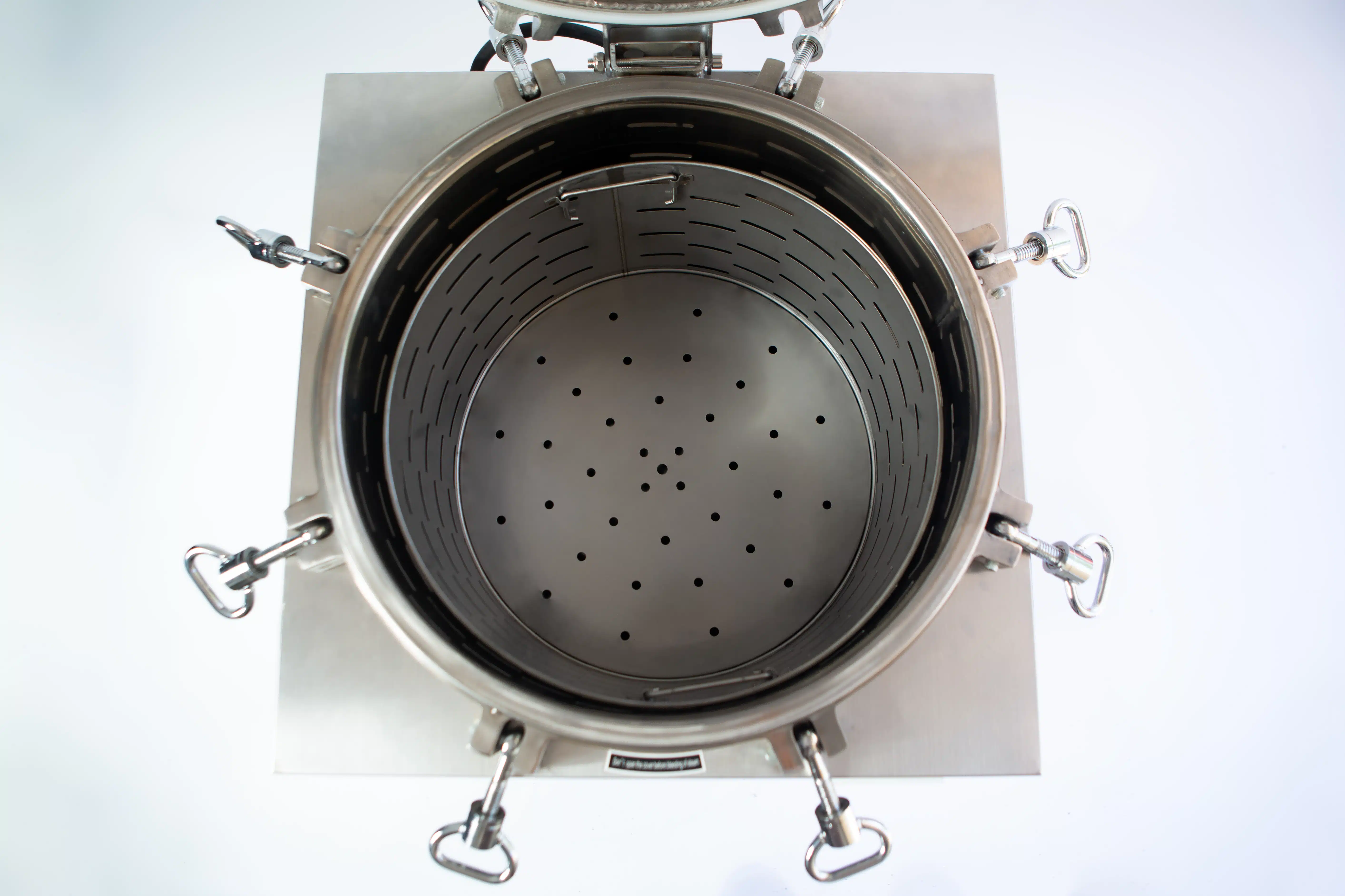 Vertical Autoclave 150 Liters (Automatic) | Commercial use | 6KW 10 Top view of an open stainless steel industrial container with a perforated plate inside.