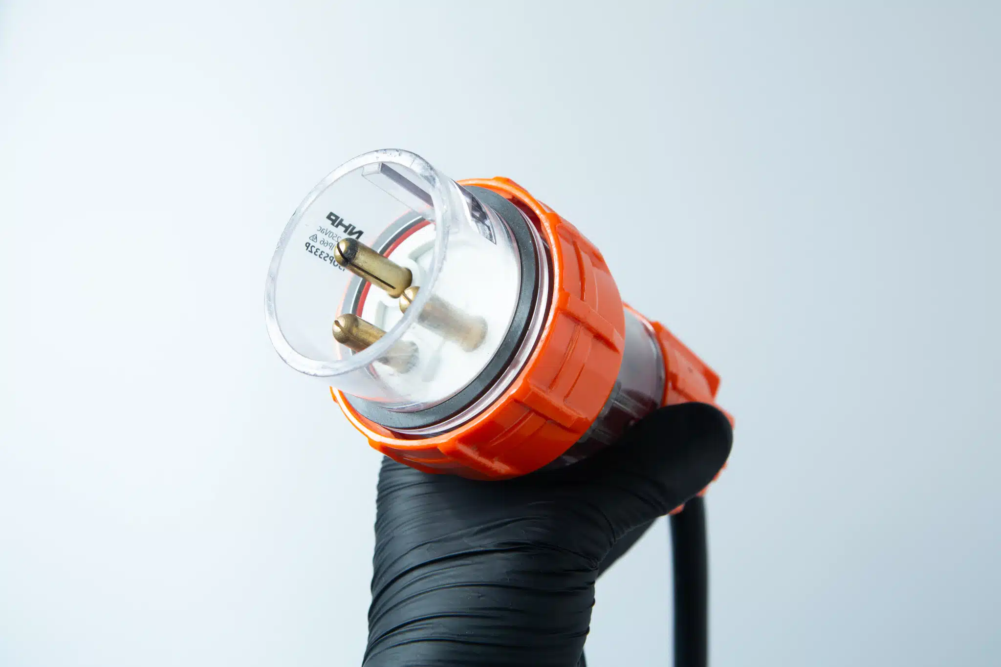 Vertical Autoclave 150 Liters (Automatic) | Commercial use | 6KW 19 A hand in a black glove holds the Vertical Autoclave 150 Litres (Automatic) | Commercial use | 6KW against a light grey background.