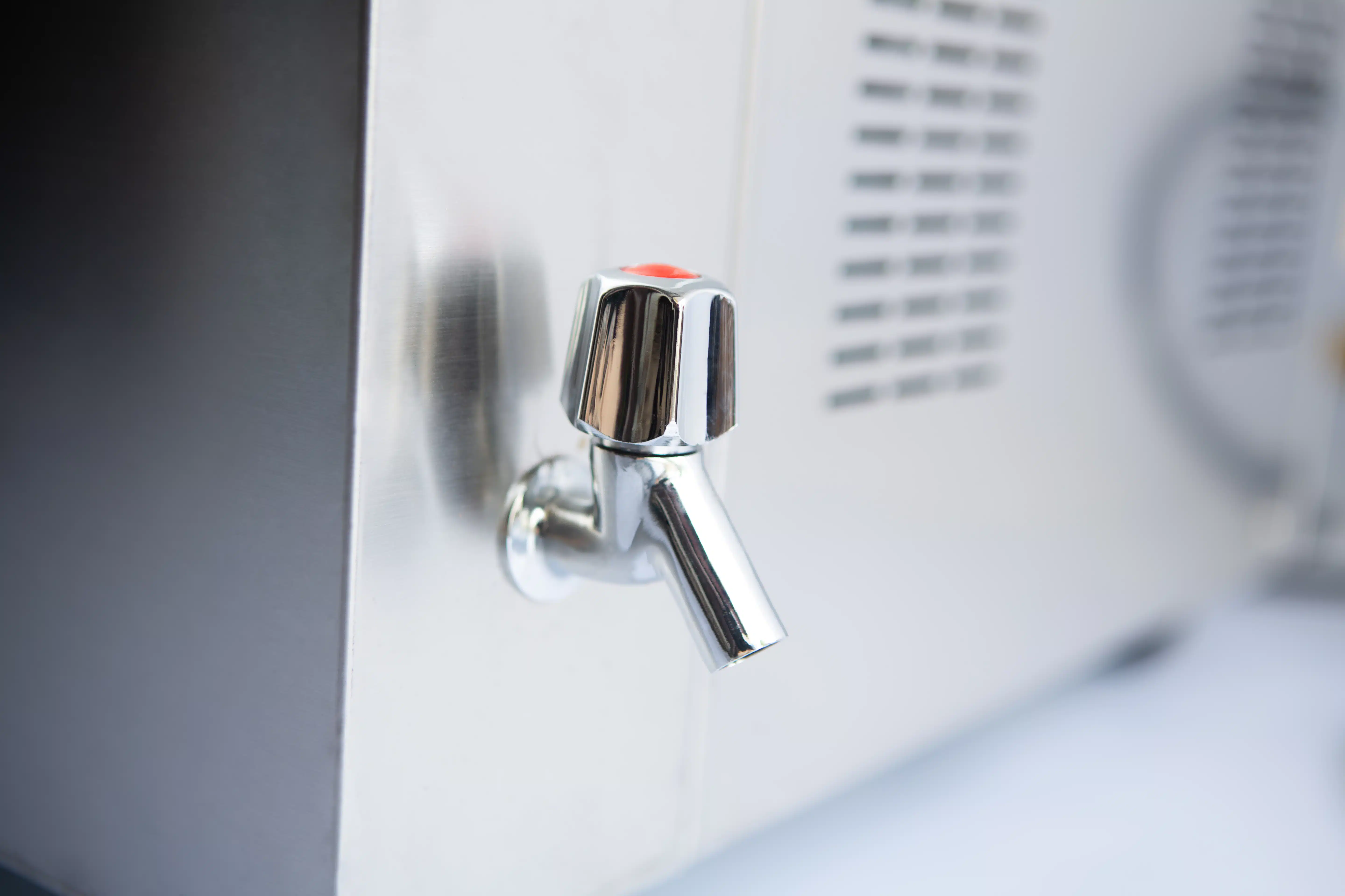 Vertical Autoclave 150 Liters (Automatic) | Commercial use | 6KW 17 Close-up of a shiny metal water tap attached to a stainless steel appliance or dispenser.