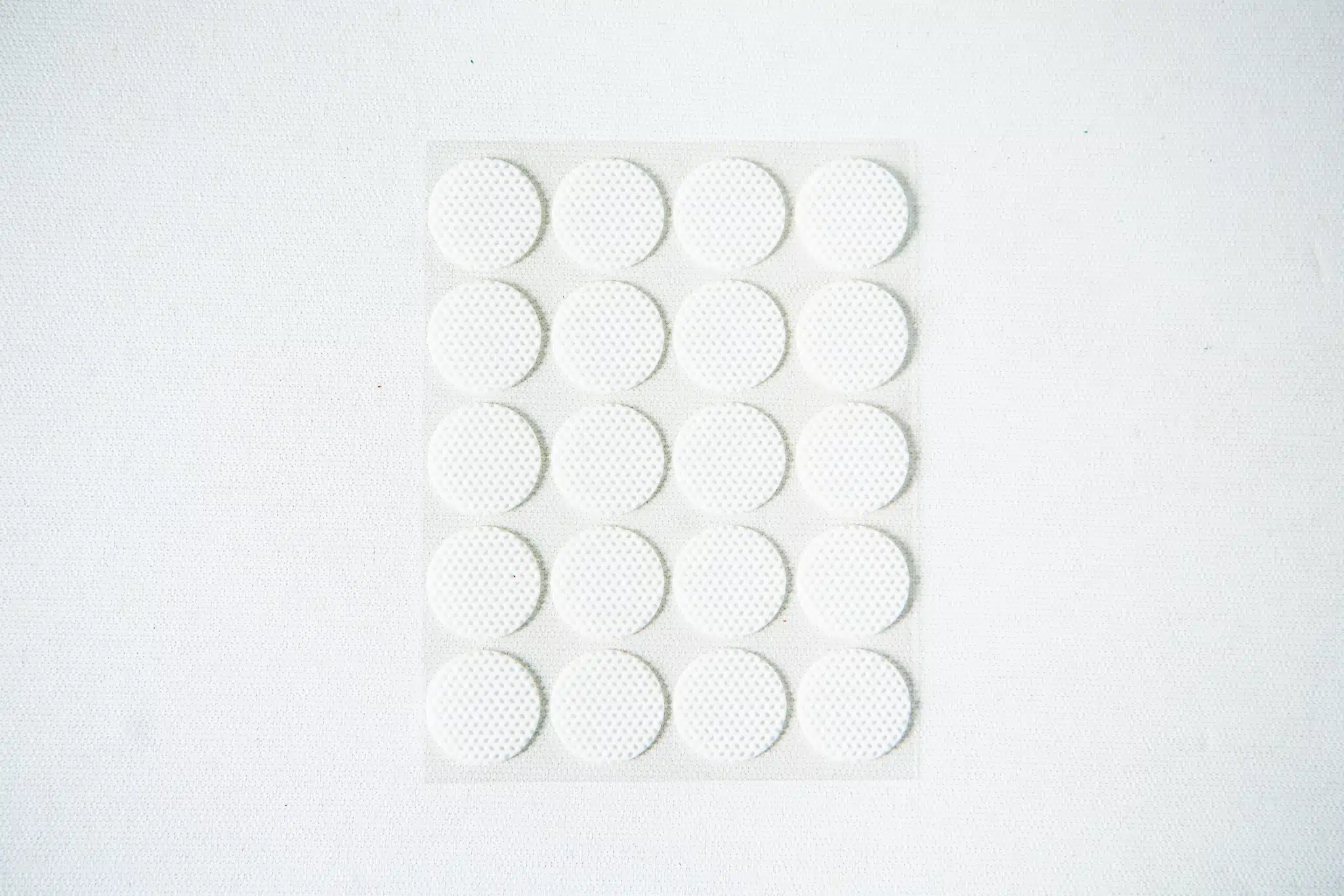 A sheet of 18 round, white adhesive labels arranged in a grid on a white background.
