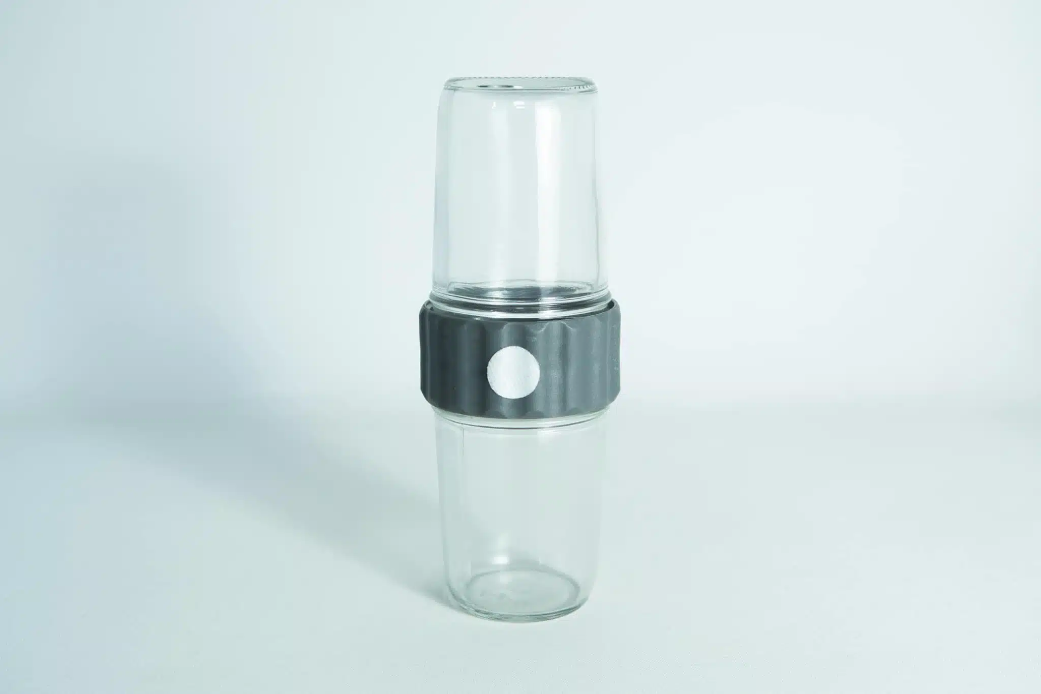 Two clear Plant Cell Biocoupler™ Glass Set cups (16oz, 12oz) are stacked with a black and white band around the middle, shown against a white background.